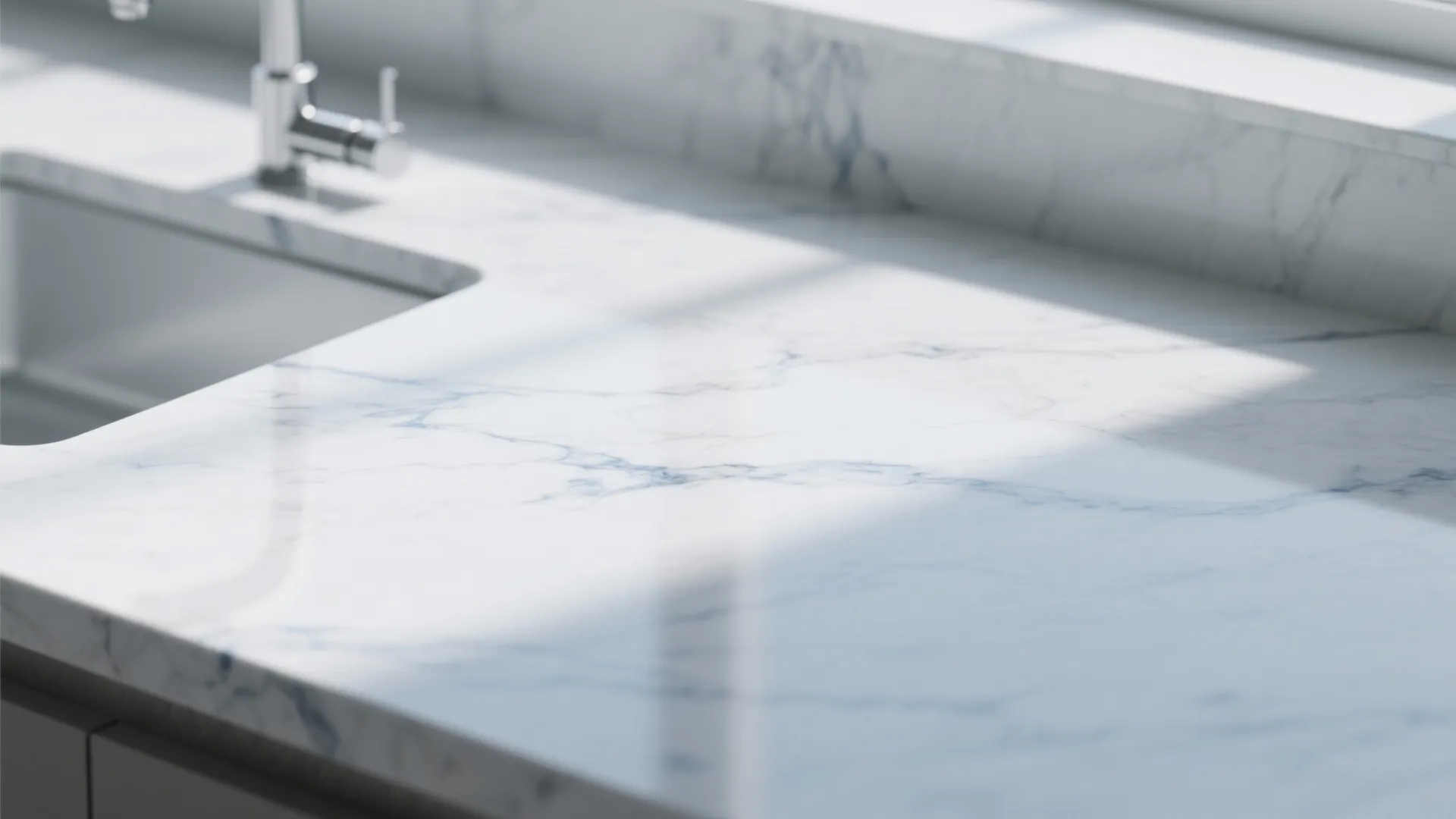Close up view of white marble countertop with blue veins and a silver water tap
