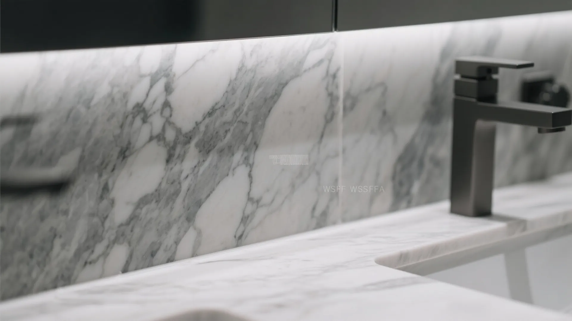 Close up of white marble bathroom countertop and wall panel with a black modern faucet