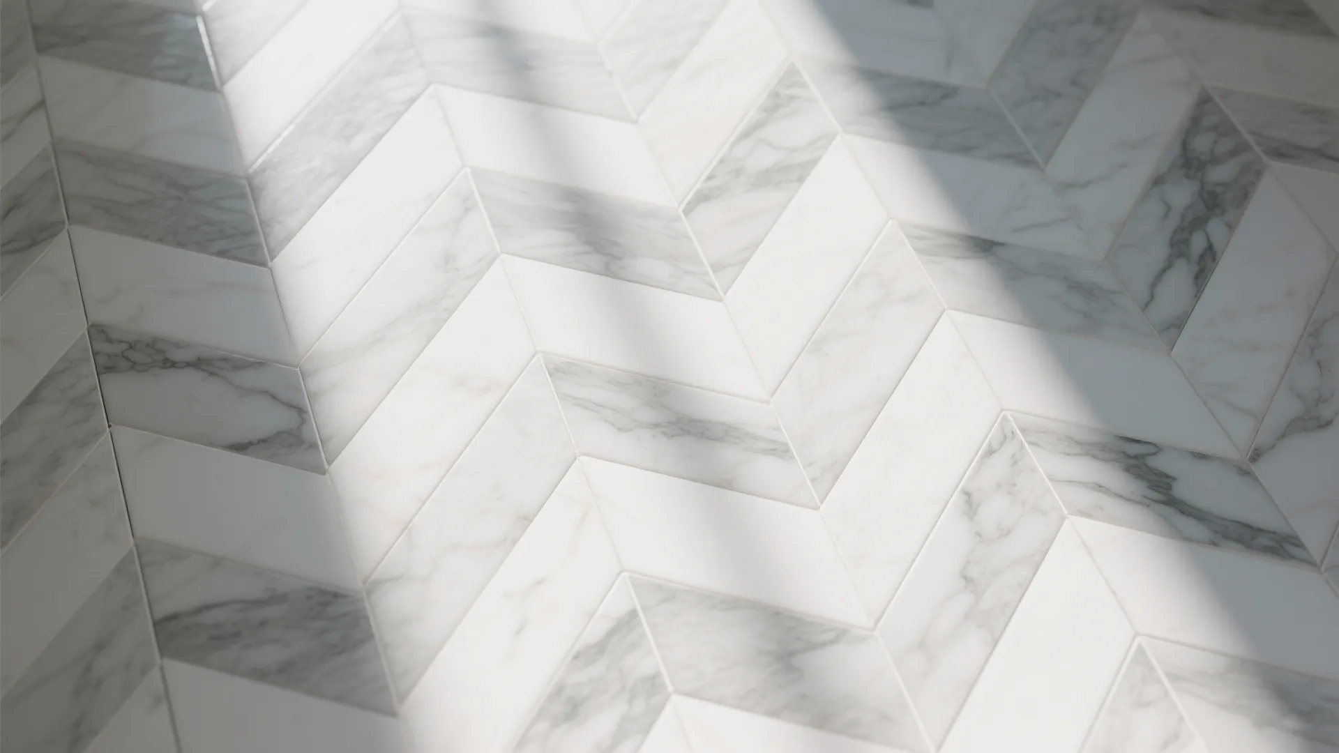 Top-down view of marble herringbone tile pattern