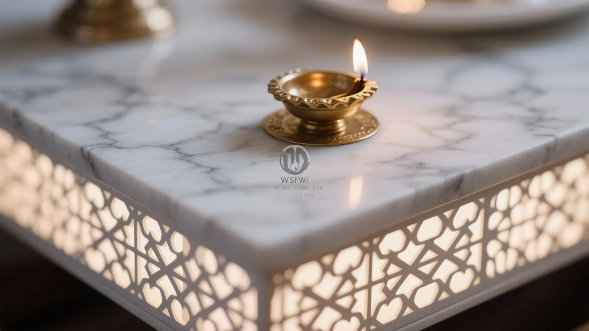 Close-up of white marble veining, brass plate, and softly backlit jaali perforations.
