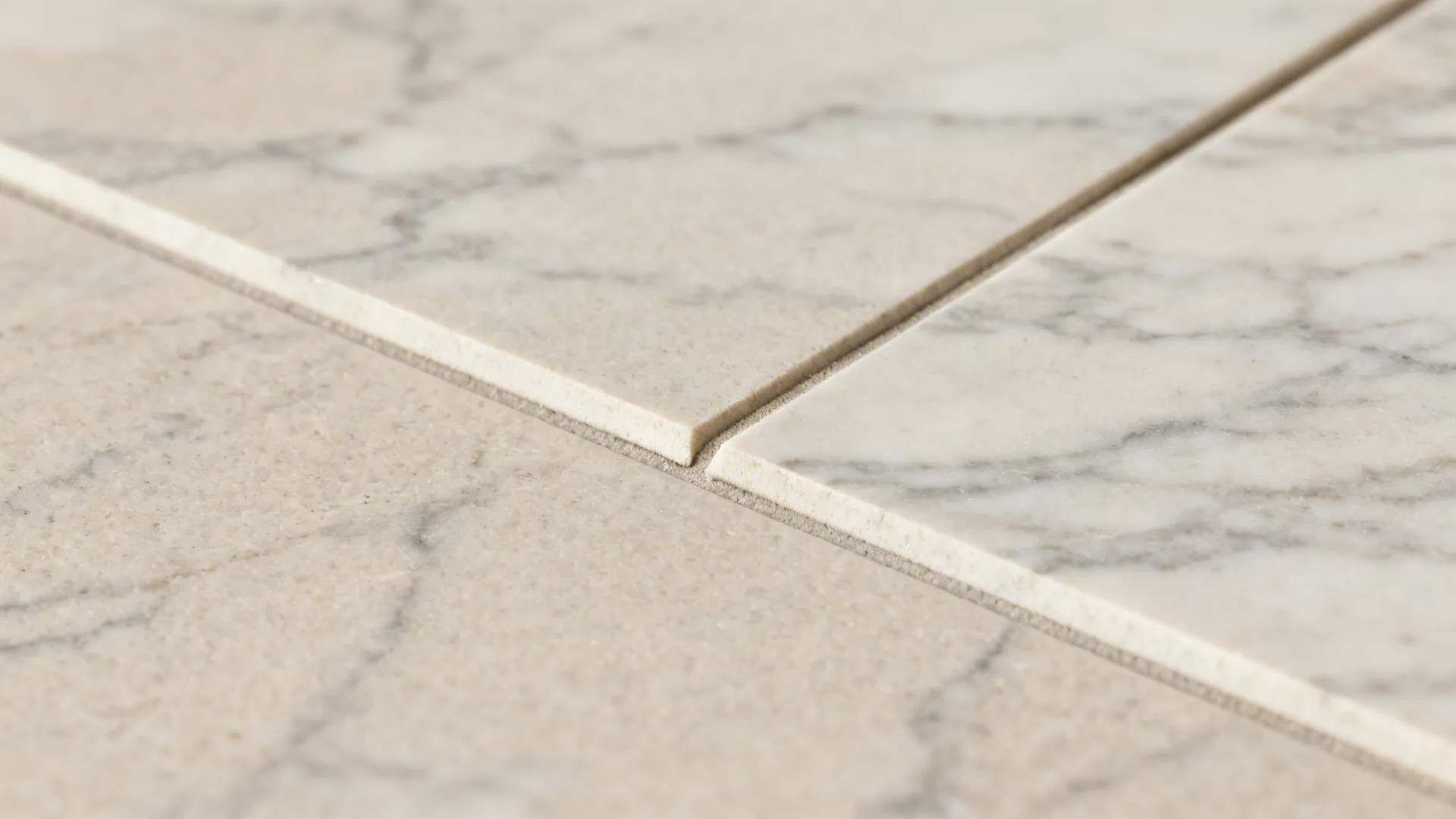 Close up view of light grey marble floor tiles showing a clean and narrow grout line