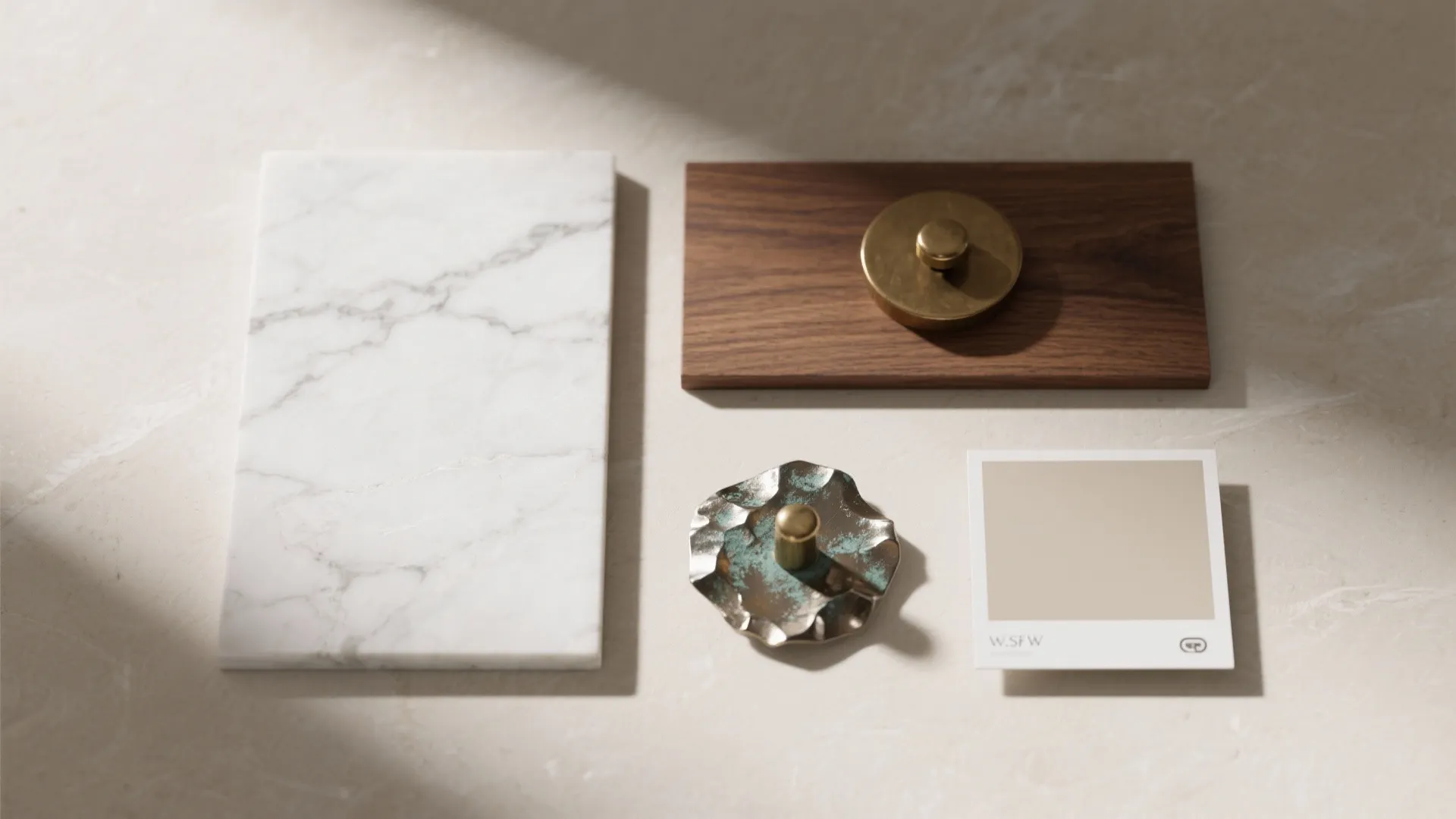 Top-down flat lay of honed marble, warm walnut, and bronzed brass forming a quiet-luxury palette.