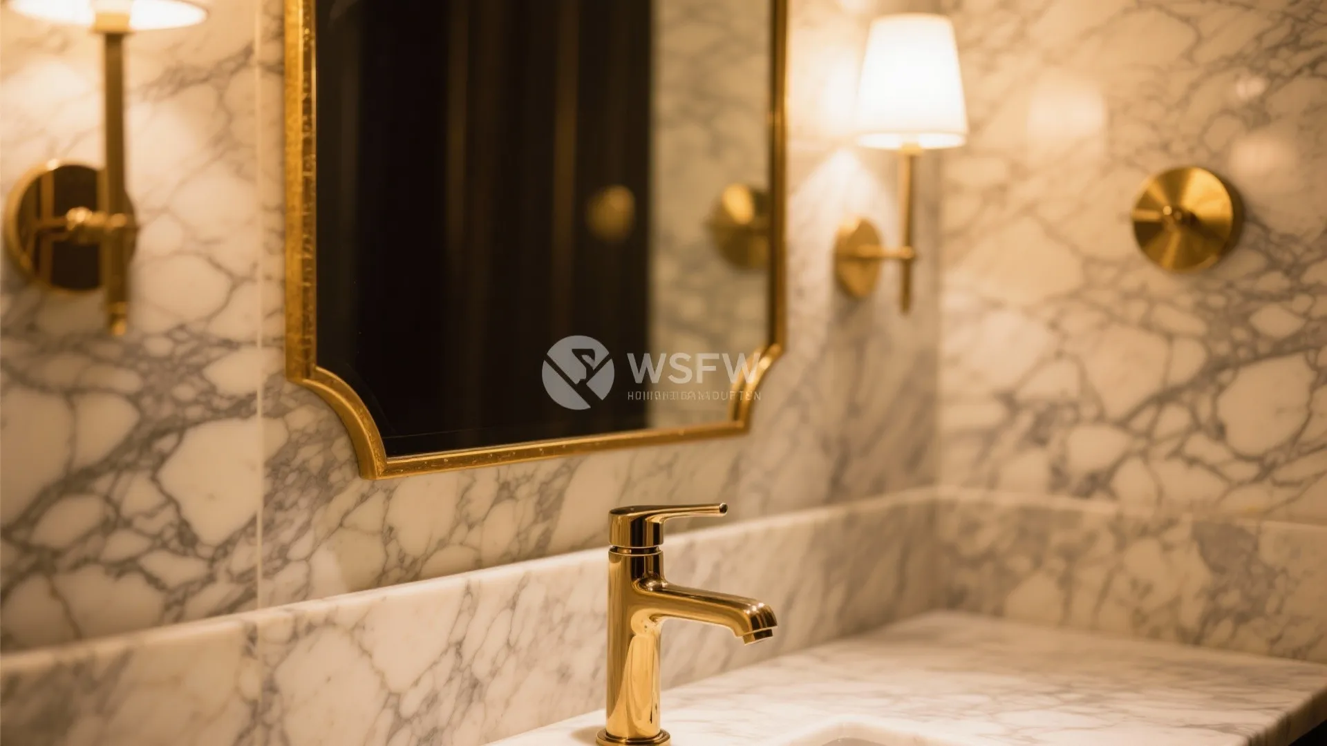 Close-up of brass faucet and gold-framed mirror on marble wall