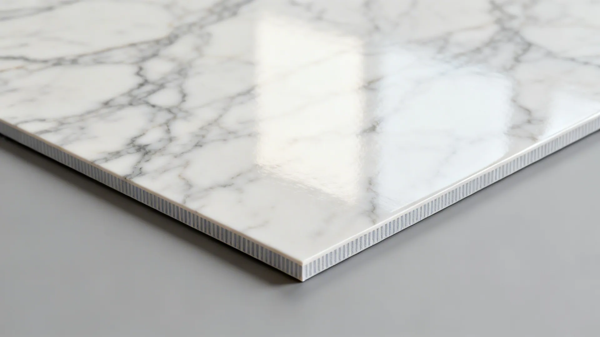 Macro of marble-look PVC showing realistic Calacatta veining and satin sheen.