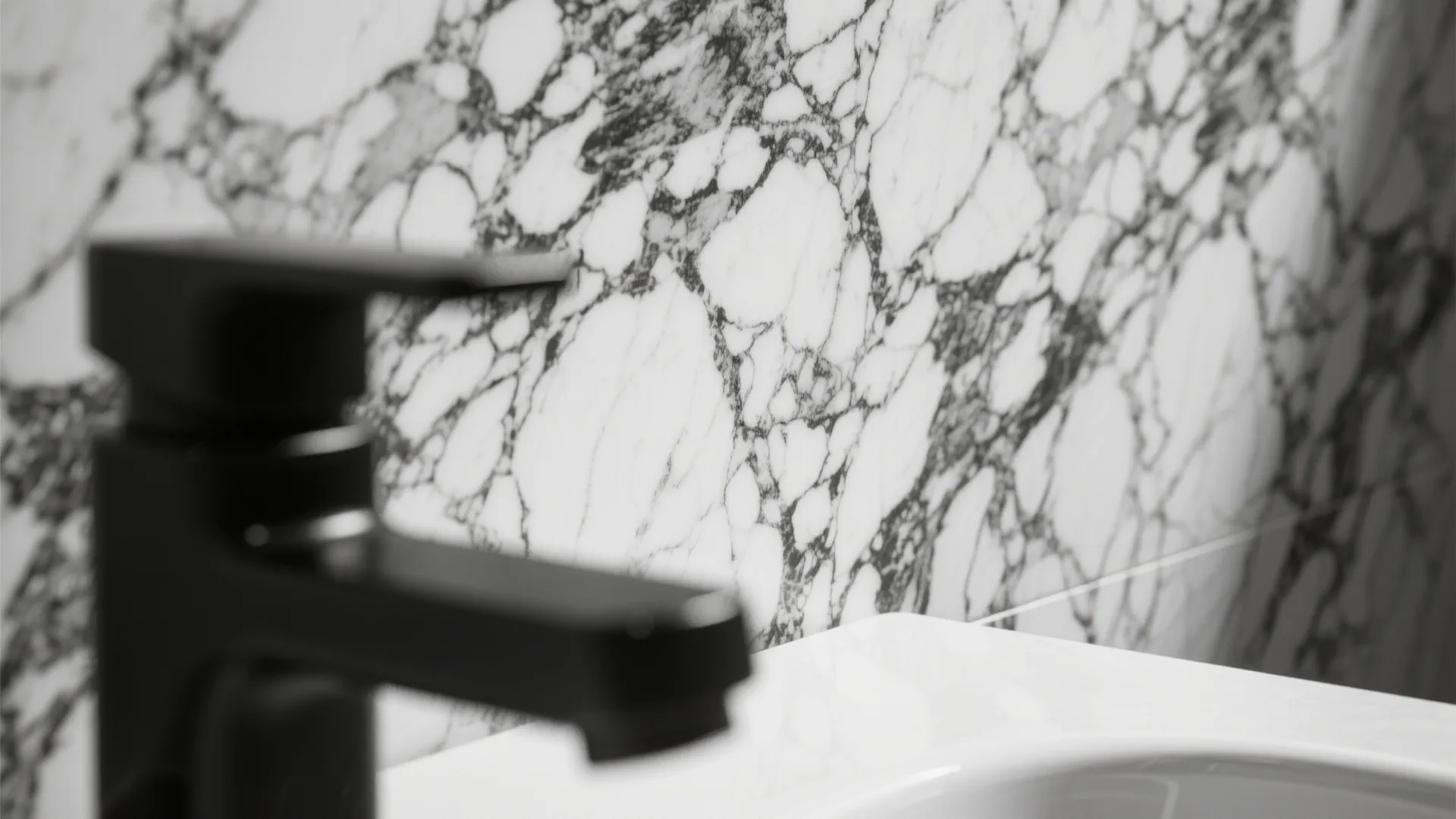 Close up of black bathroom faucet with white marble wall background and white ceramic sink