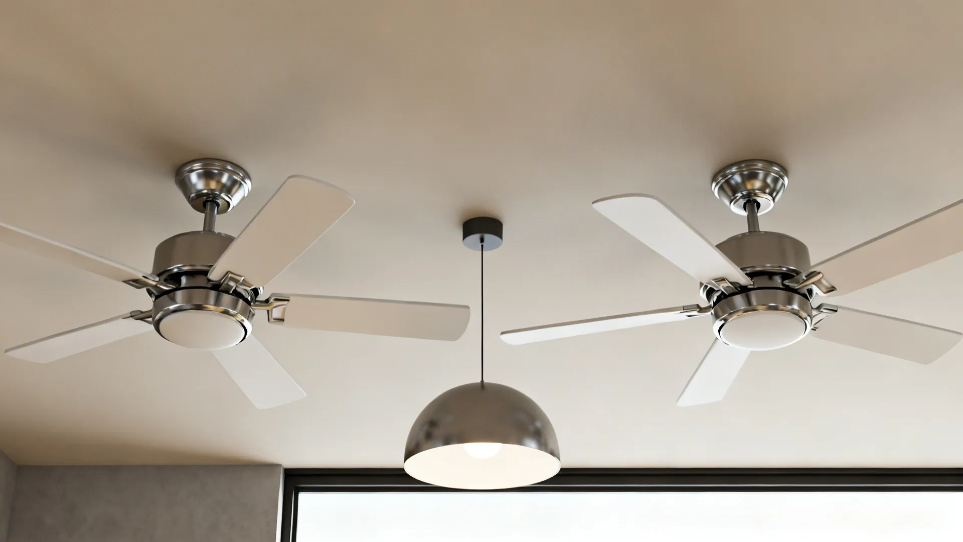 Two matching ceiling fans with a shared finish and a central pendant between them for cohesion