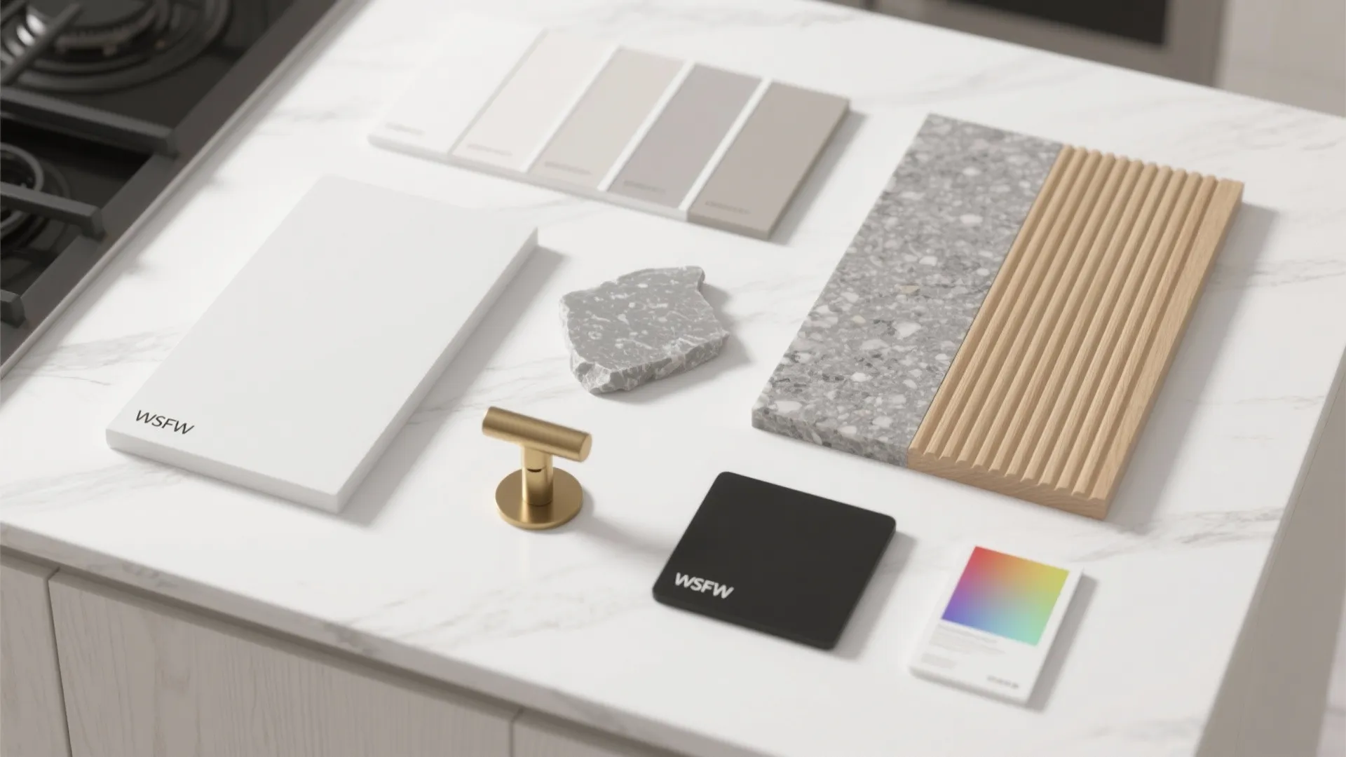 Flatlay of paint, wood, quartz, and hardware samples for white wood kitchens