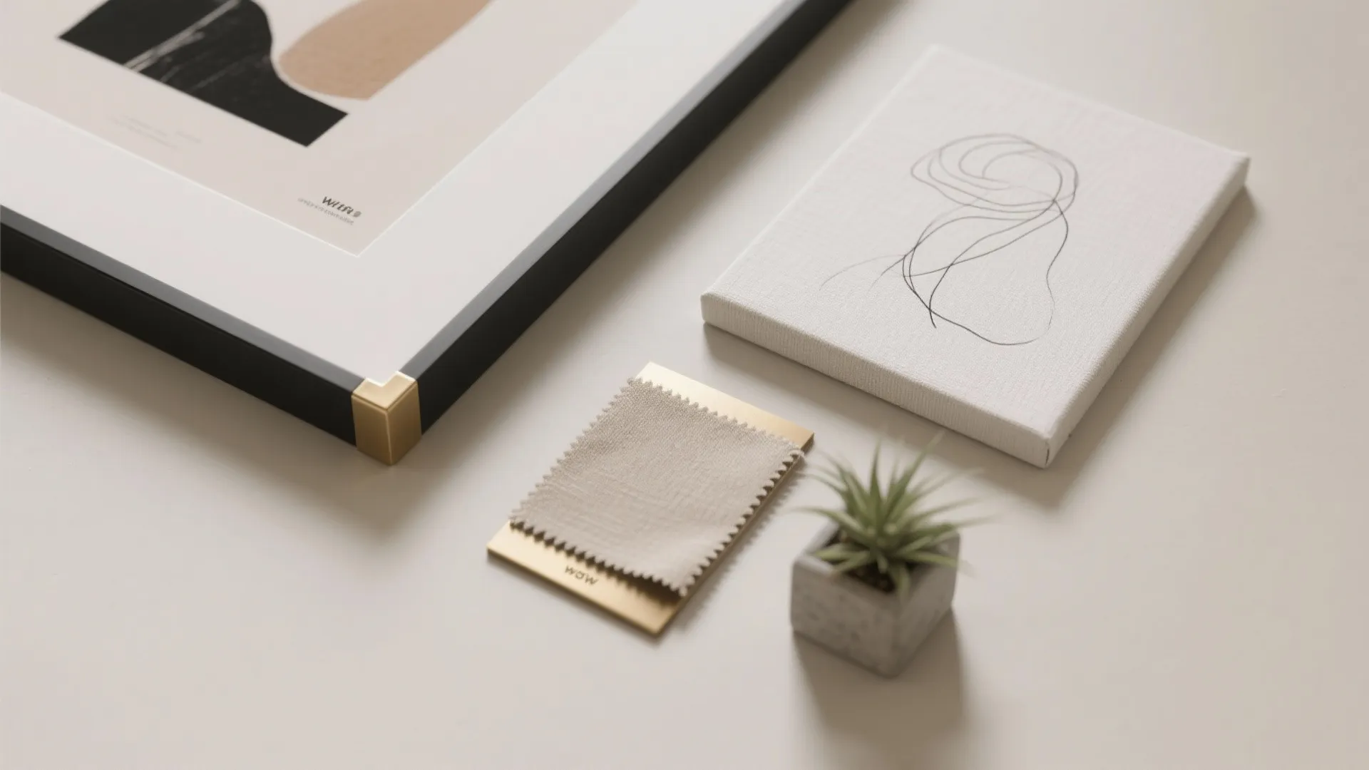 Interior design material board with framed art small canvas fabric swatch and tiny green plant