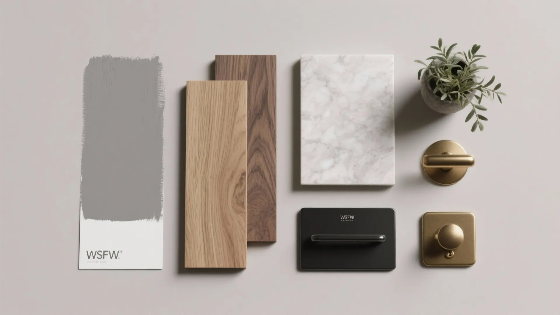 Interior design material board with grey paint sample wood flooring marble tile and gold hardware