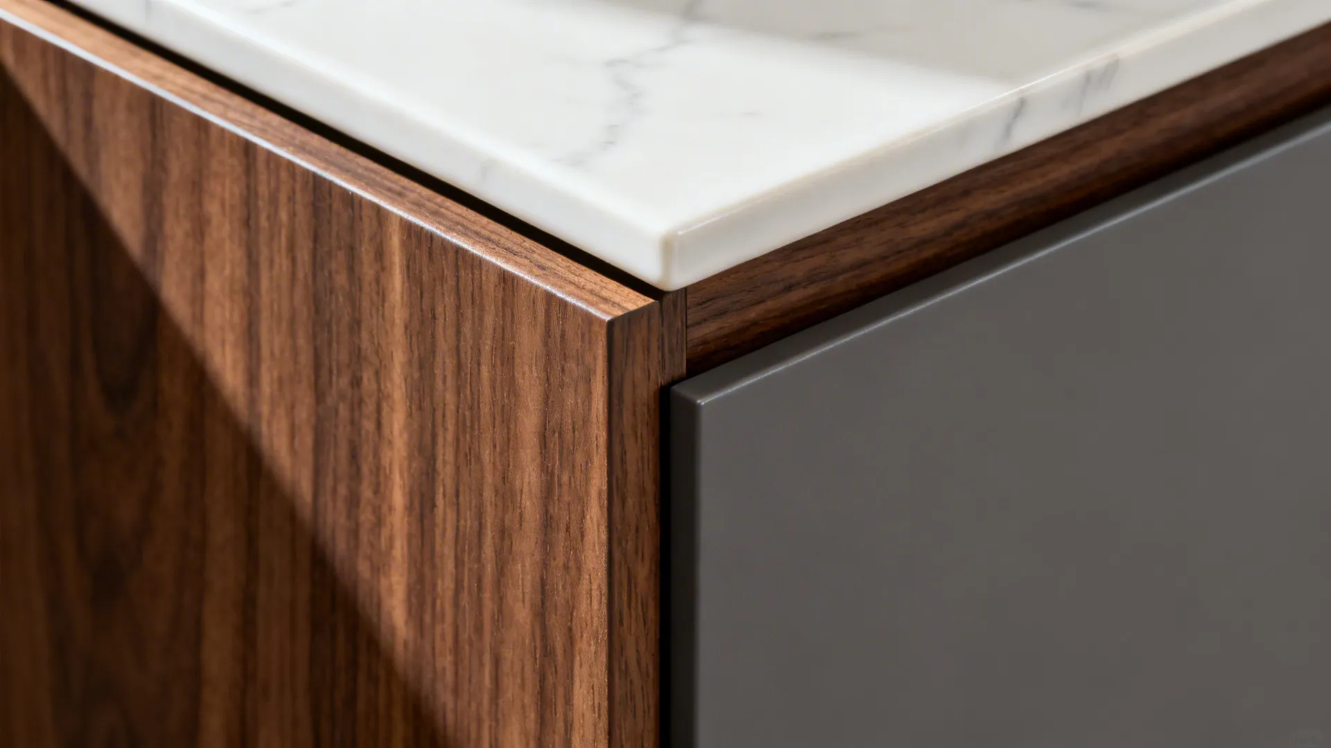 Close-up of porcelain, walnut veneer, and matte lacquer junction with clean shadow gap.