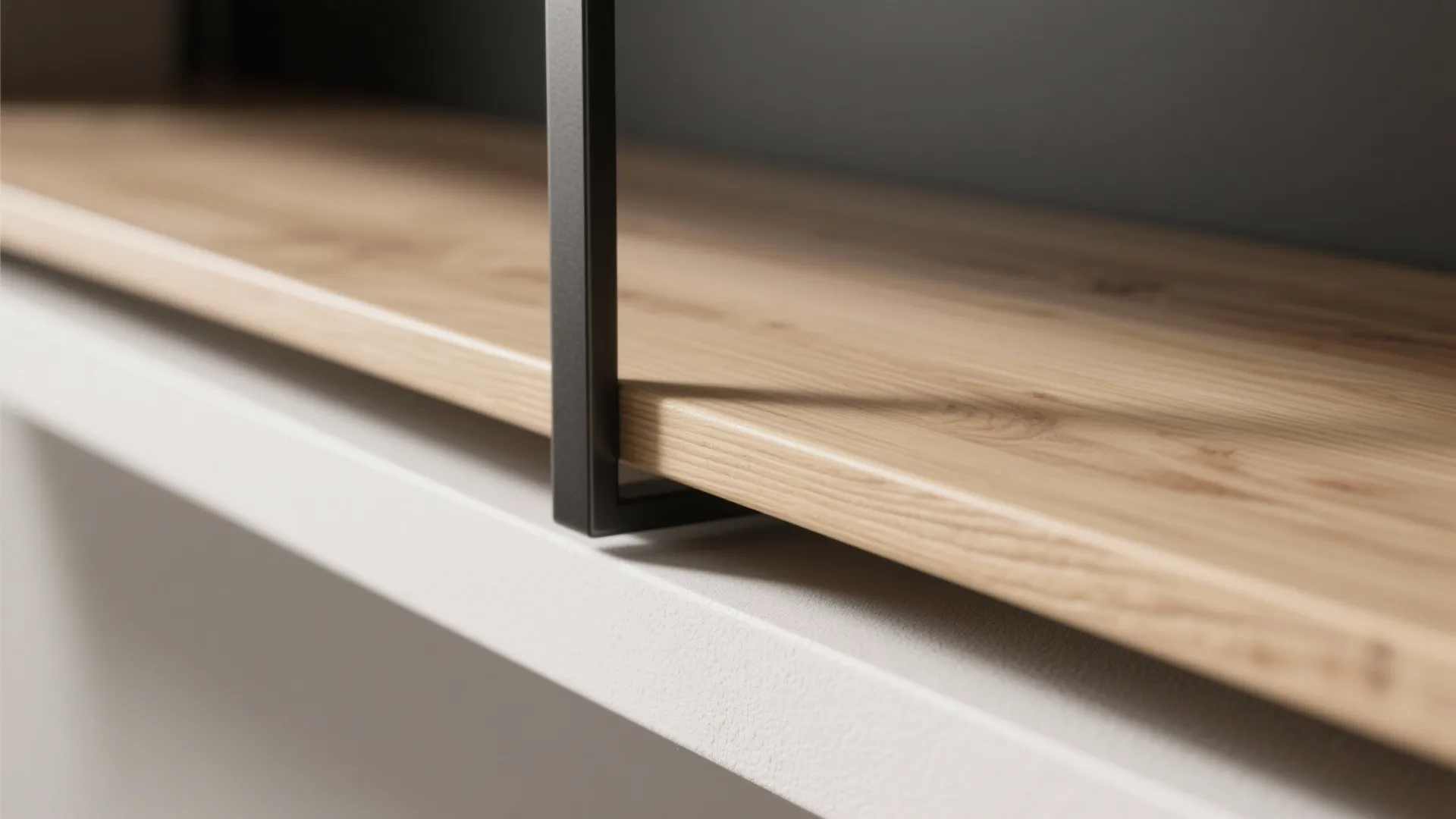 Close up of light wood shelf with black metal frame and white wall background texture