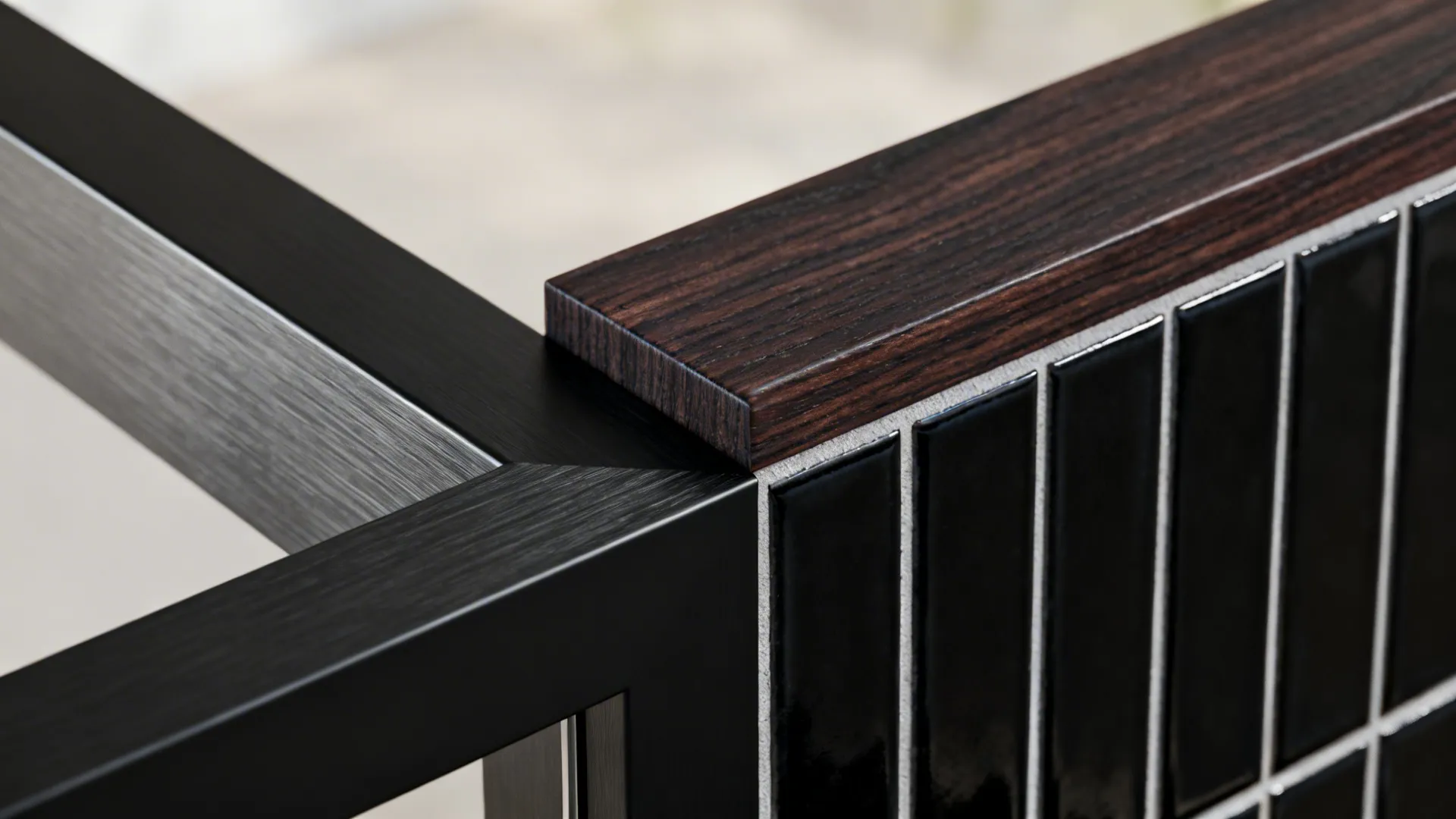 Close-up showing mixed black trim materials: matte metal, dark-stained wood, and slim black tile.