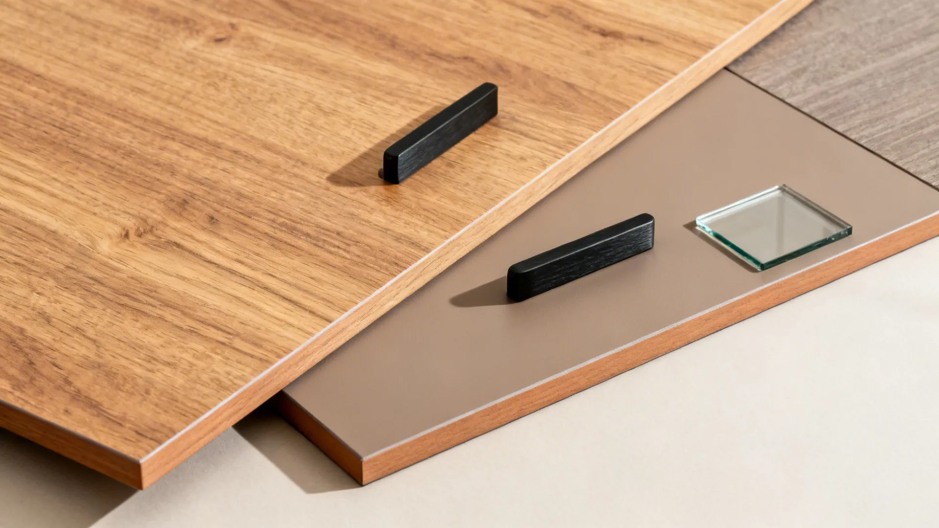 Flat lay of oak veneer, matte laminate, melamine interior, ABS edging, and black hardware.