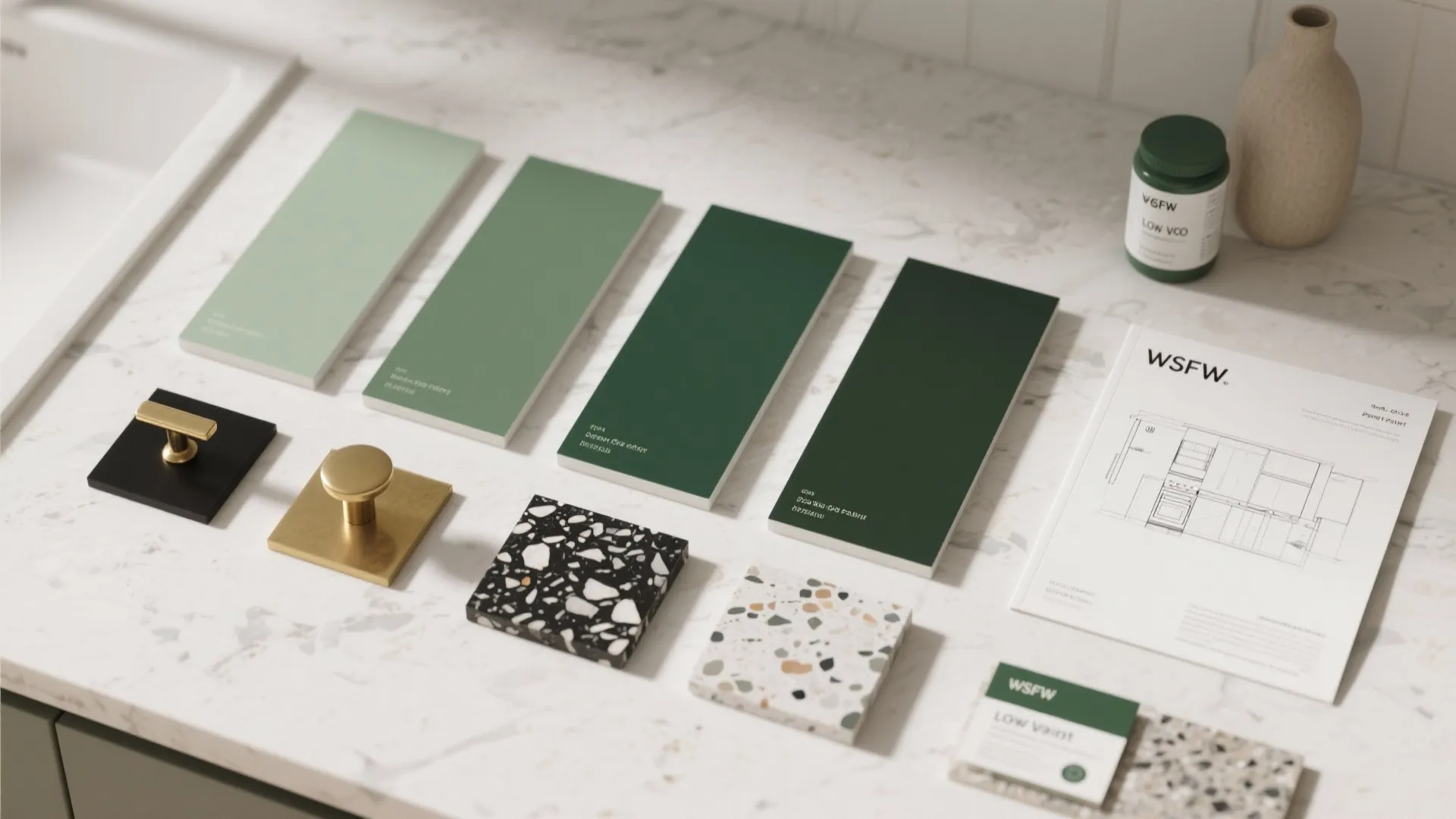 Material flatlay with green paint swatches, hardware samples and countertop chips