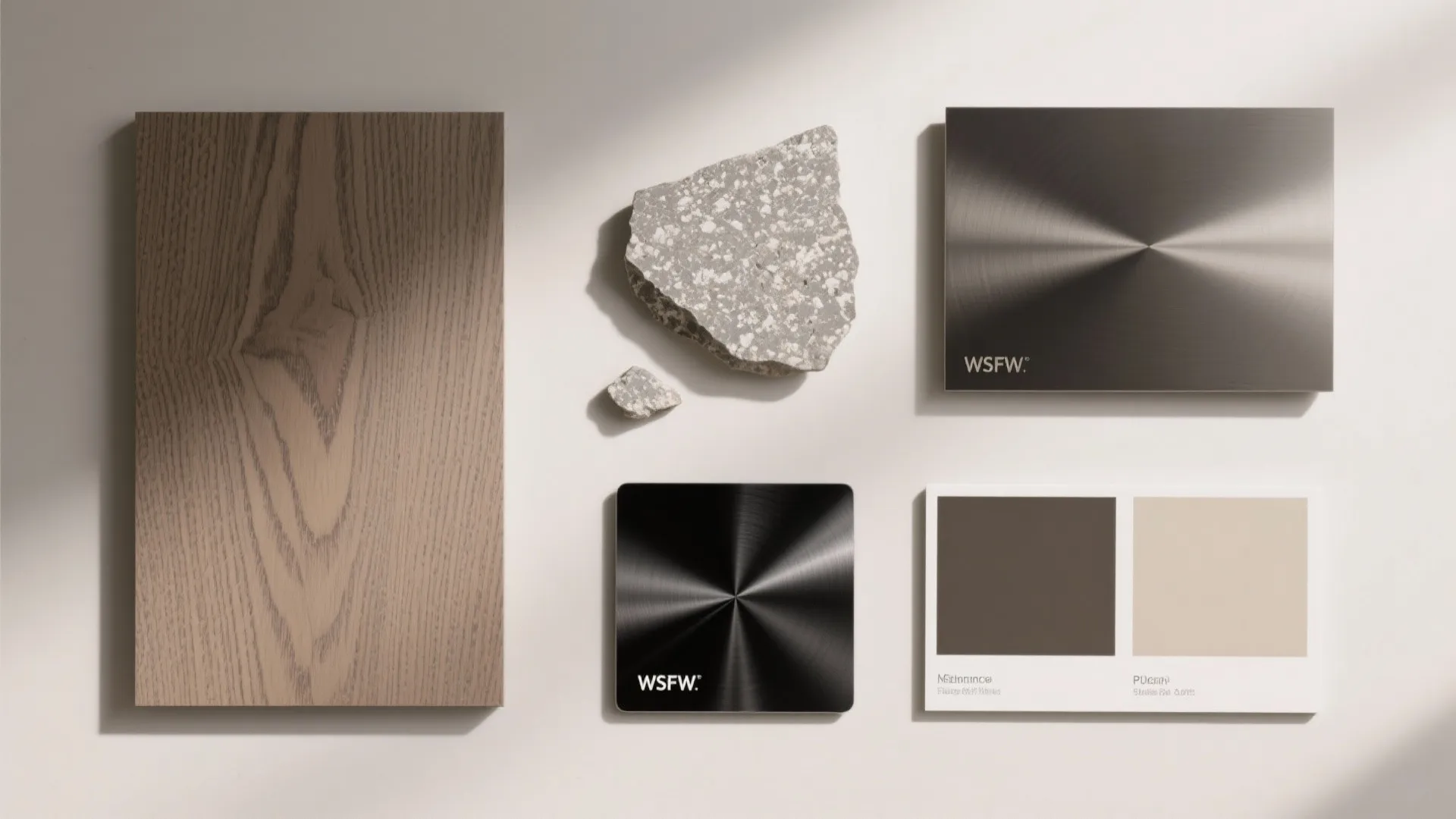 Material palette with wood panel, stone, metal samples, and color cards for interior design planning