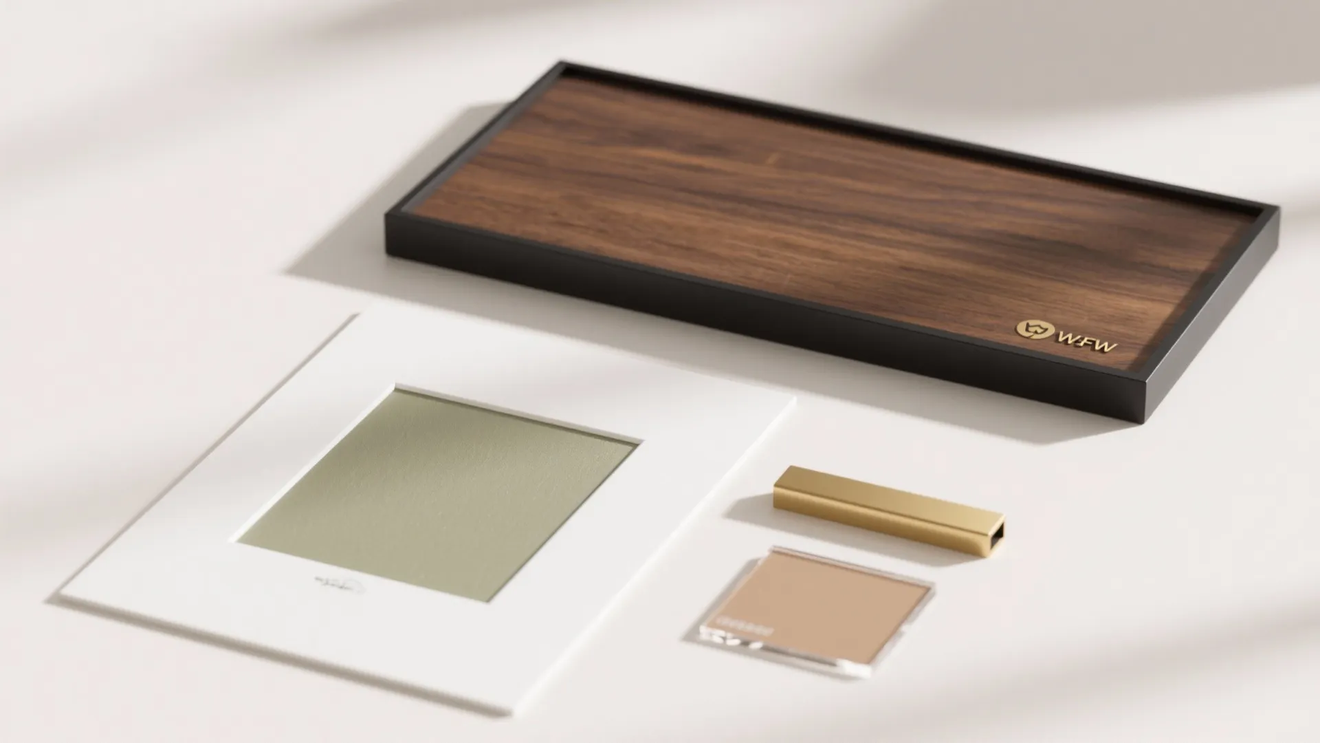 Interior design material flat lay with wood sample dark tray gold handle and color swatches