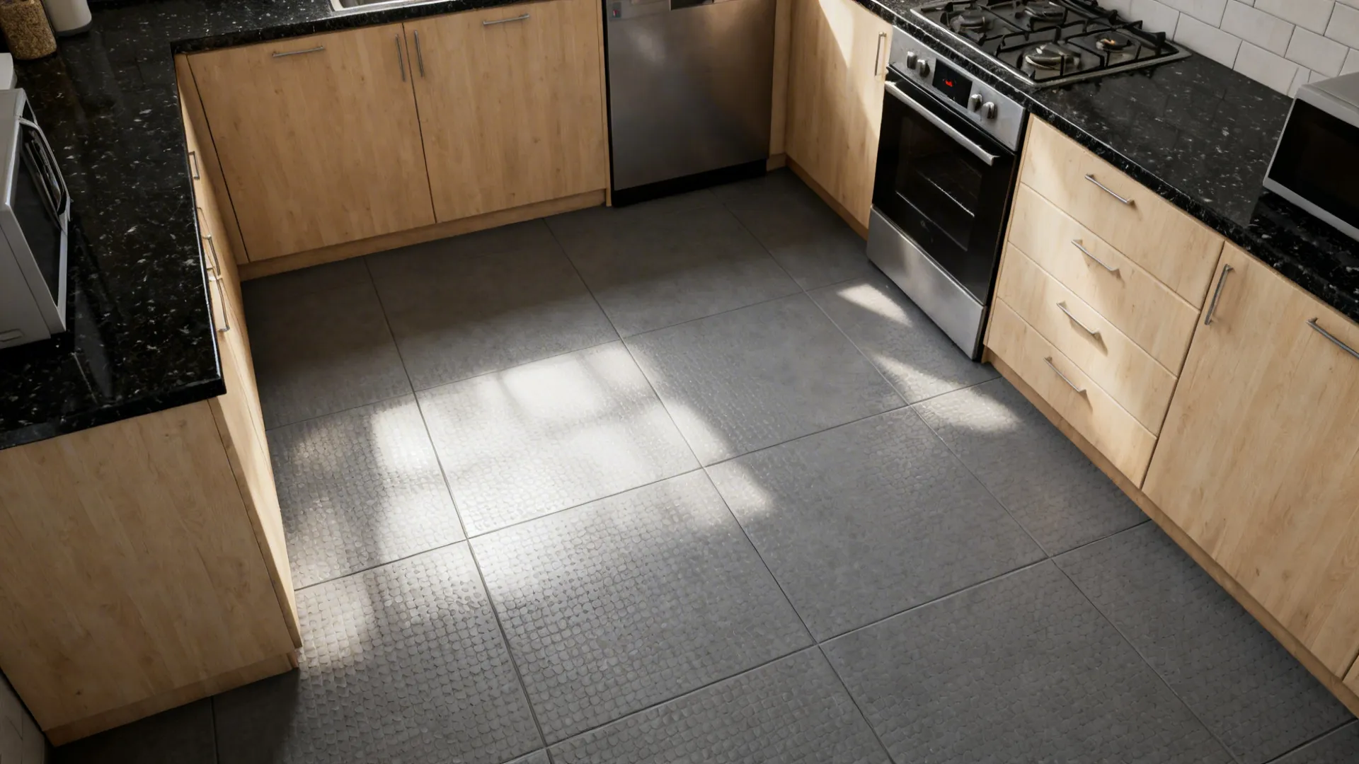 Compact kitchen with medium grey micro-textured matte anti-slip floor tiles and warm wood cabinets.