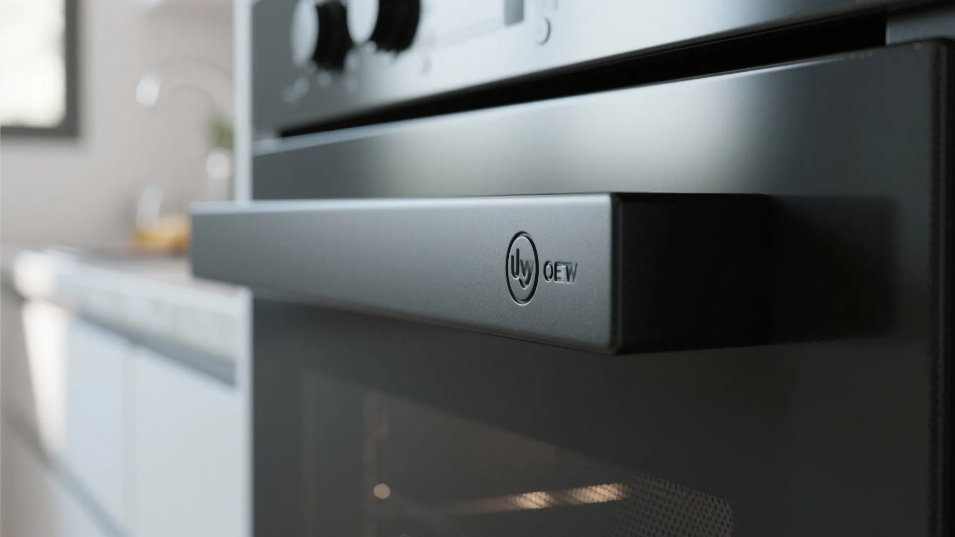 Close up detail of matte black kitchen oven handle and control dial in a house