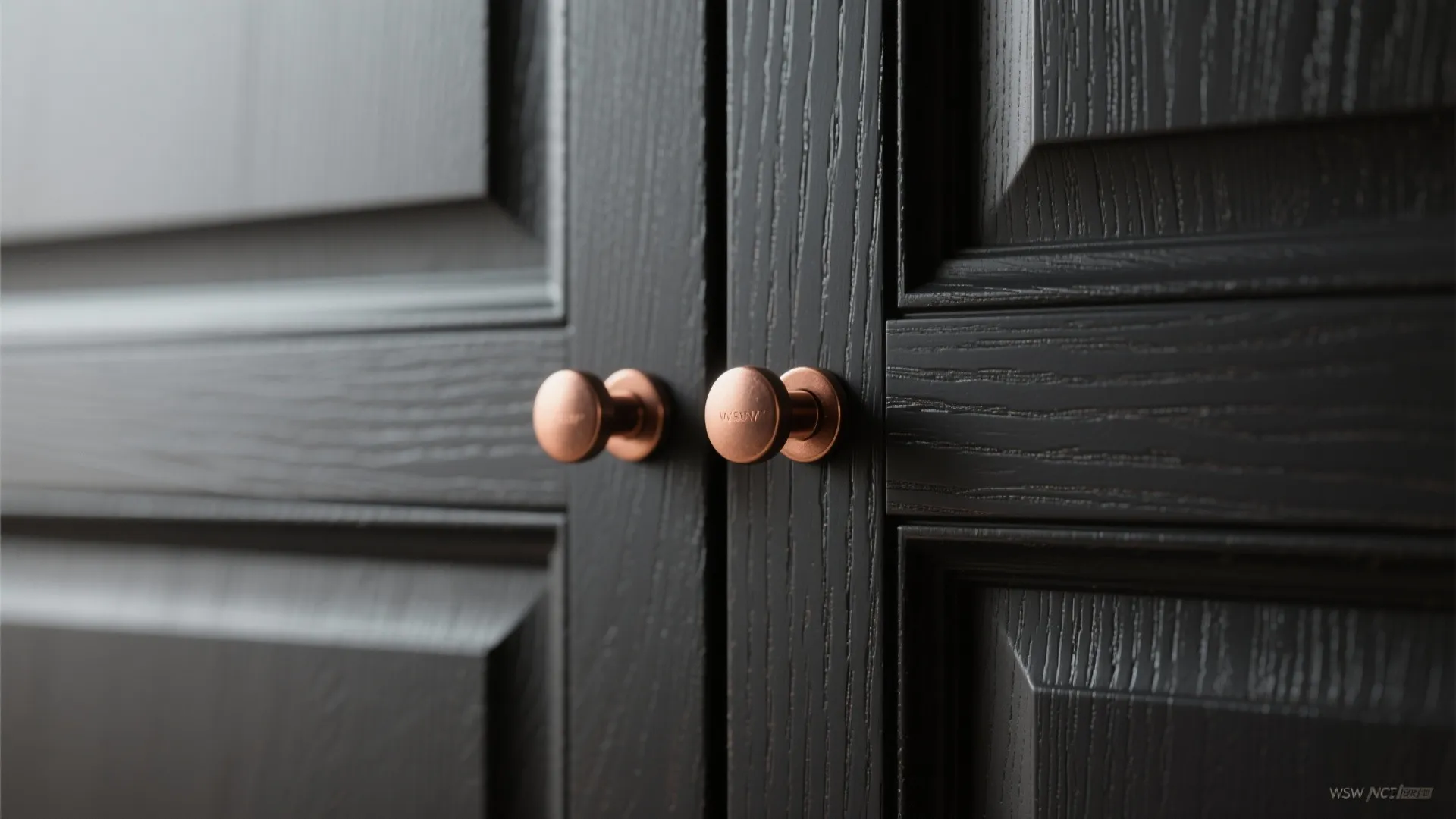 1. Matte black cabinets with copper handles
