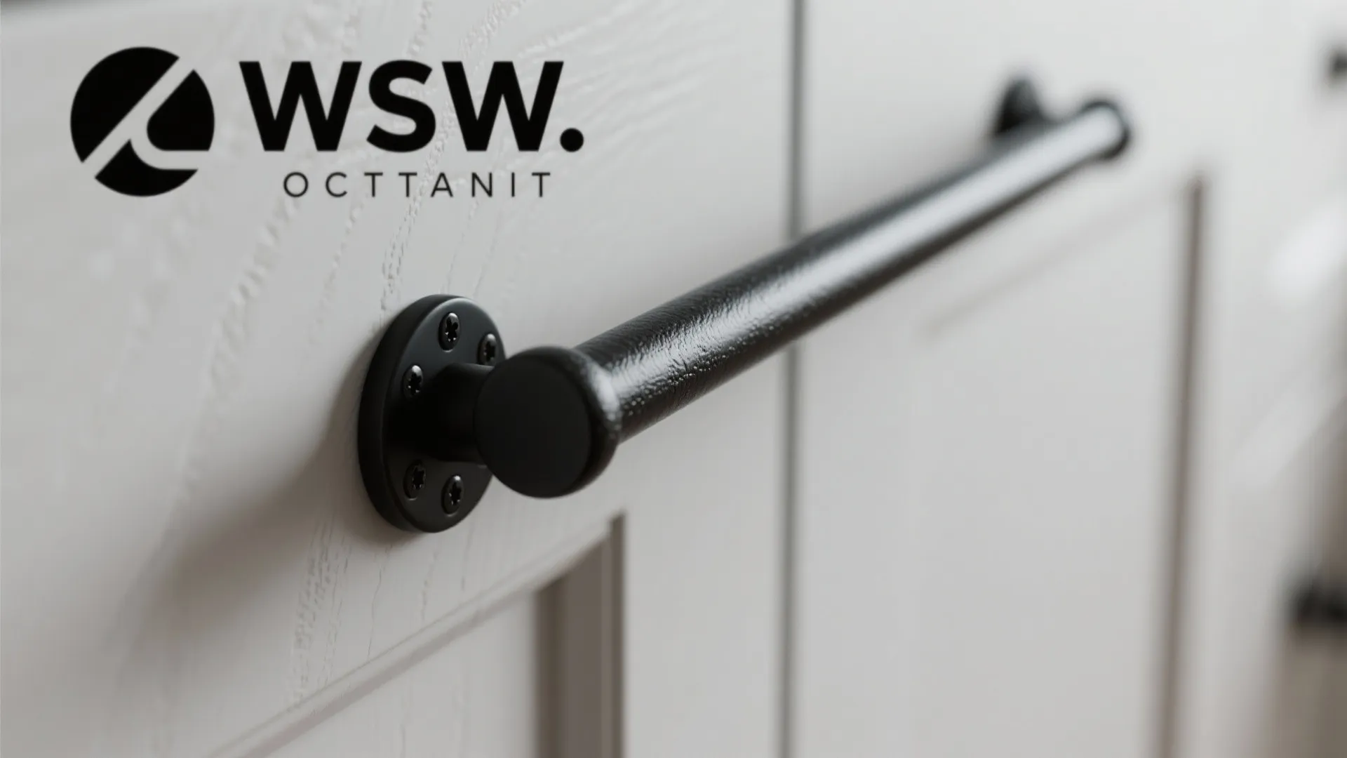 Long black metal handle on white cabinet drawer with textured surface and simple modern brand logo