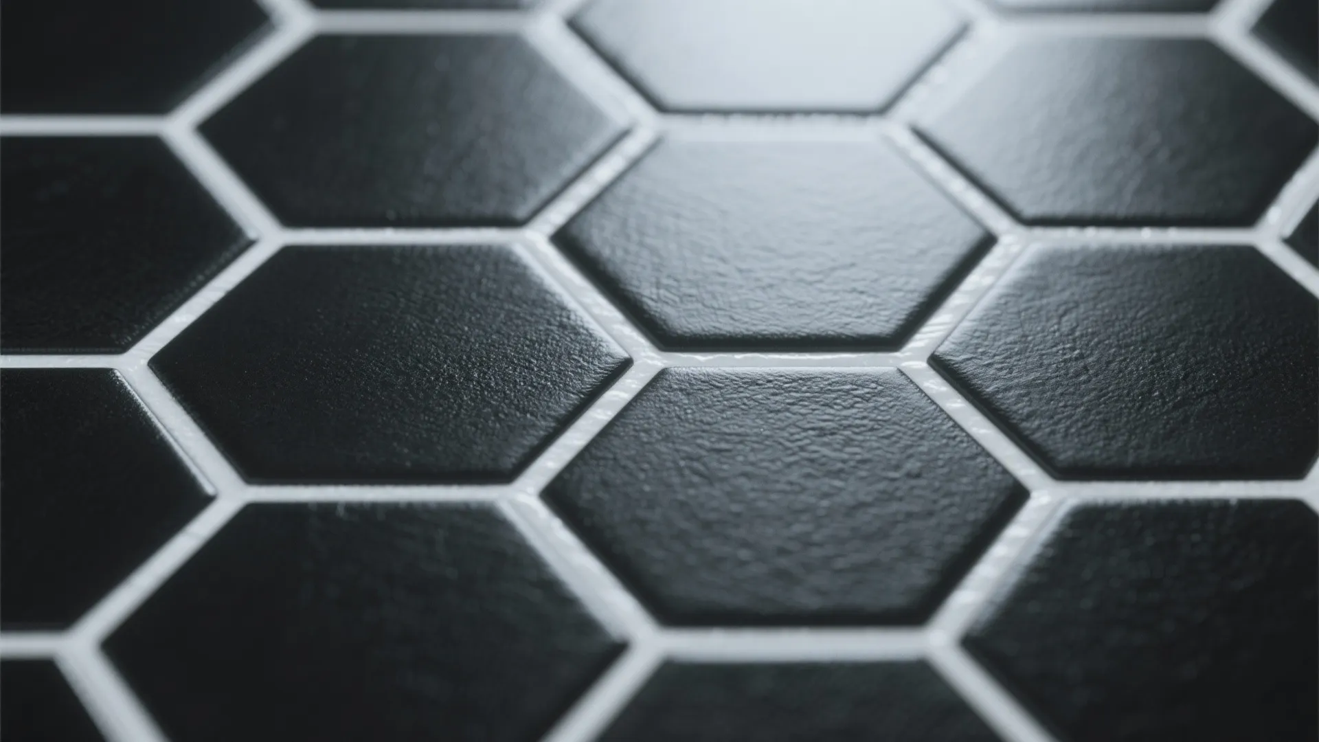 Close up view of matte black hexagon floor tiles with clean white lines between them