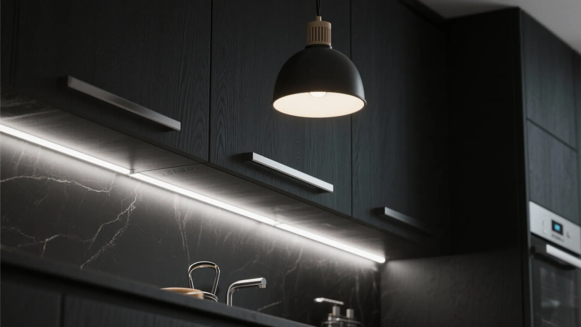 Modern black kitchen cabinets with under cabinet light strip and a hanging black ceiling light