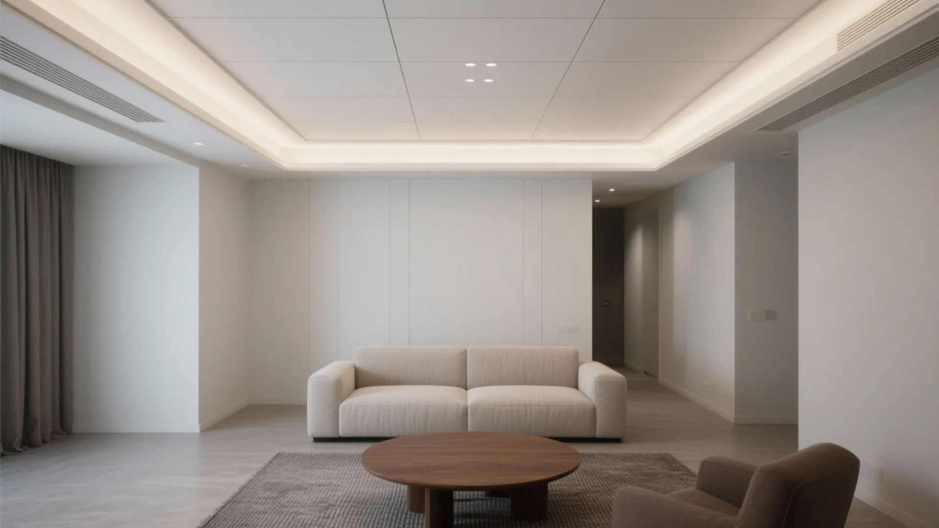 Minimalist white living room featuring a recessed ceiling light grey sofa and round coffee table furniture
