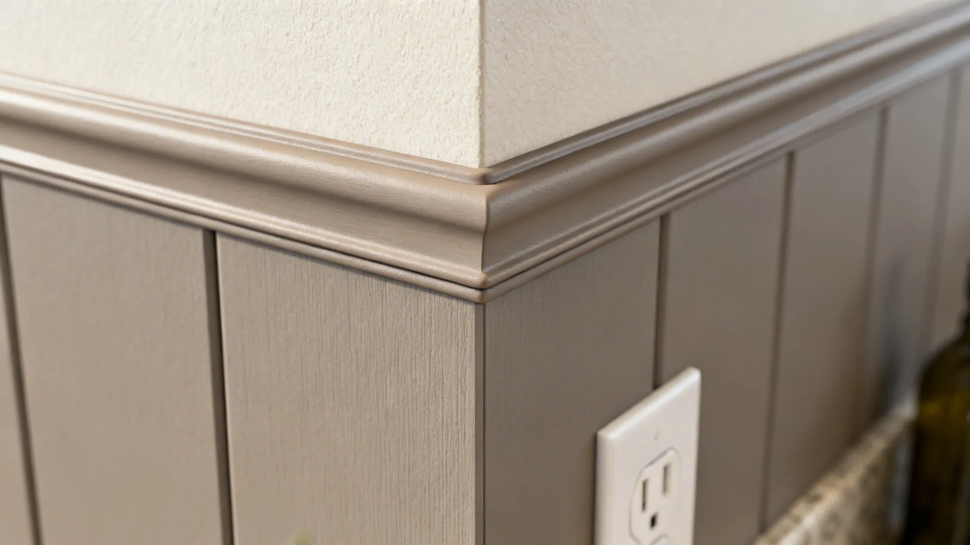 Macro detail of matte PVC backsplash with color-matched silicone around an outlet.