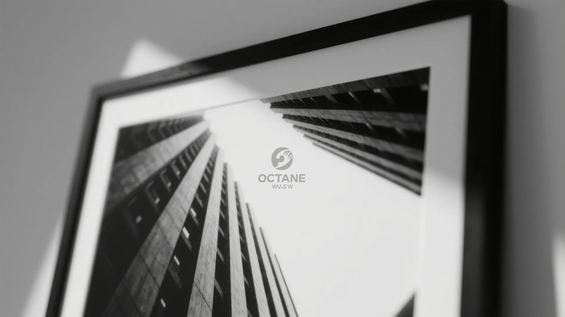 Black frame picture showing tall buildings from a low angle with sunlight on a wall