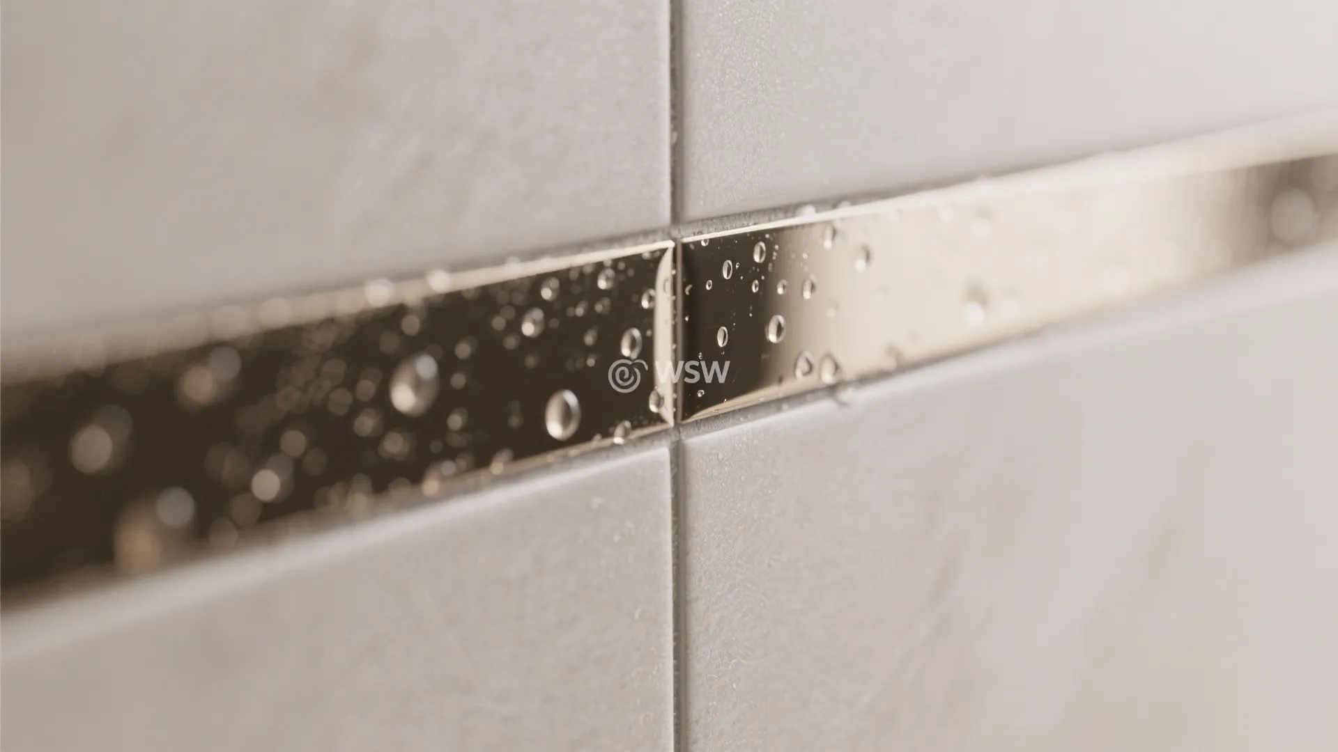 Close up of a metallic wall tile strip with water droplets in a modern clean room