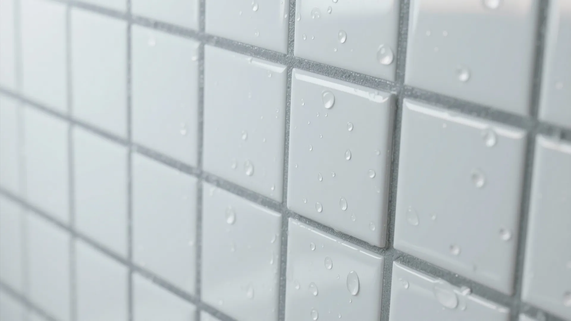 Close up view of white square bathroom wall tiles with water drops and grey grout