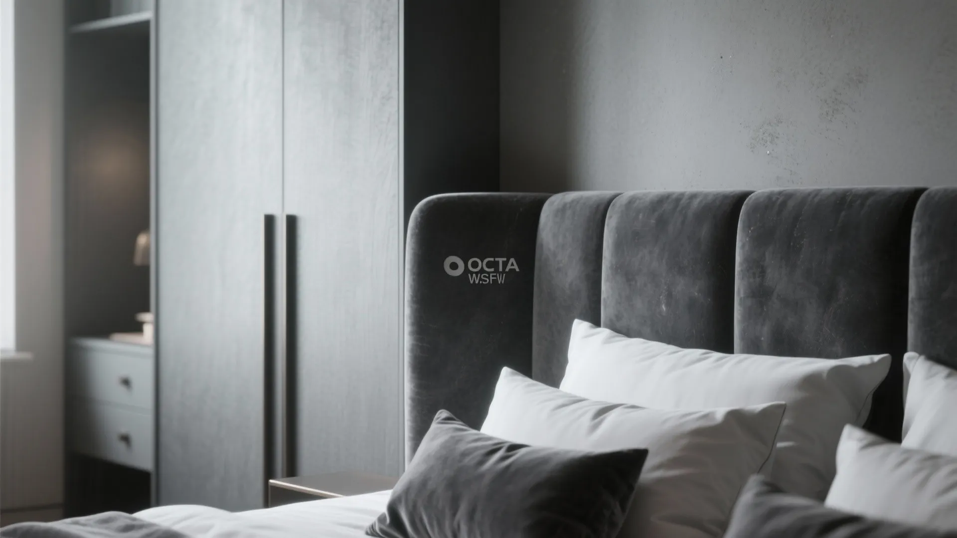 Close-up of matte dark gray headboard with plush linens and velvet cushions