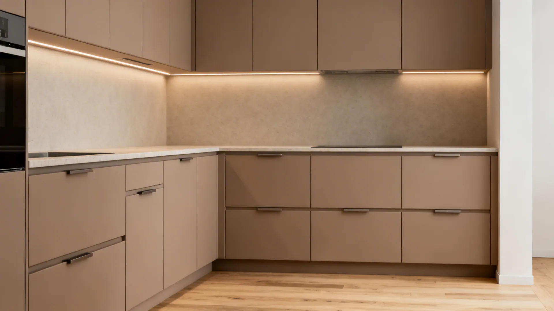 Minimalist matte slab kitchen cabinets with integrated hidden pulls in a small space.