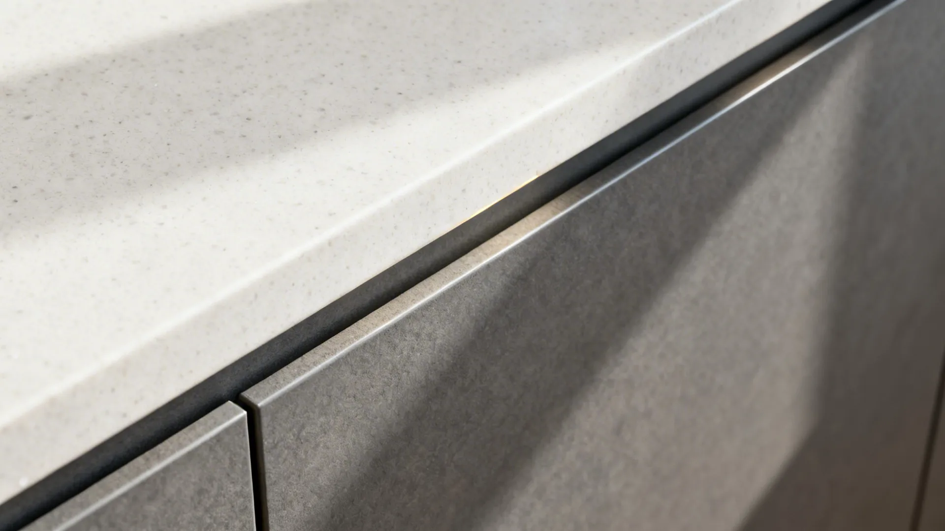 Macro of matte graphite mica cabinet with clean edge banding and quartz counter.
