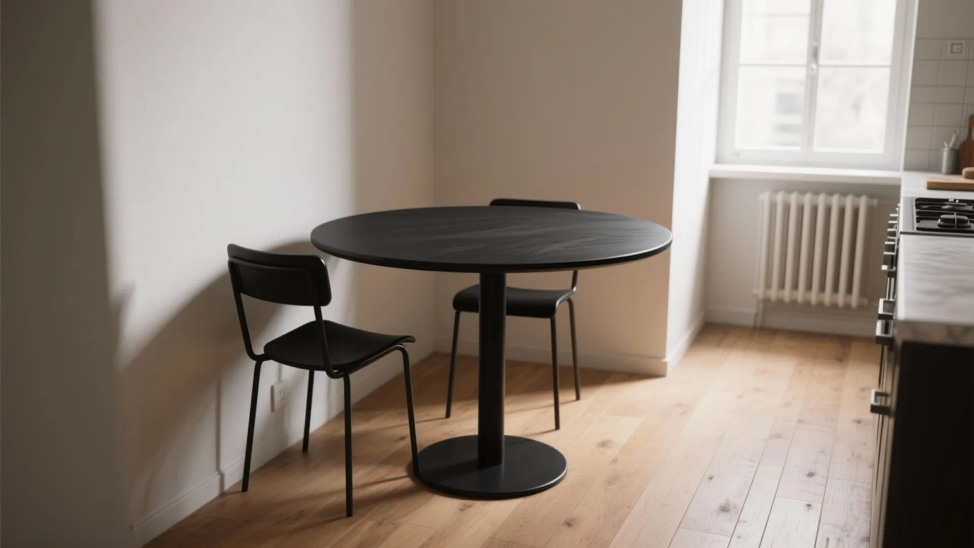 1. Matte black pedestal table with slim chairs