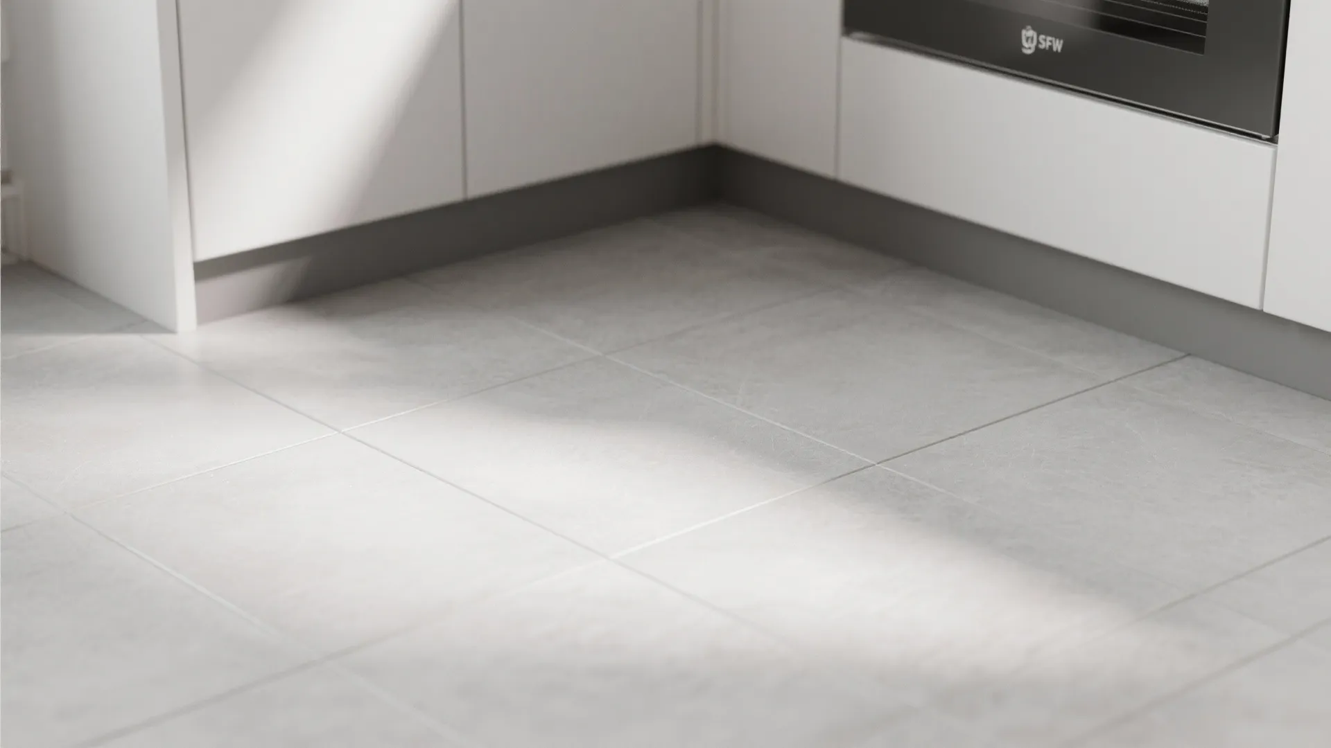 Modern kitchen with light grey floor tiles white cabinets black oven and bright morning sunlight