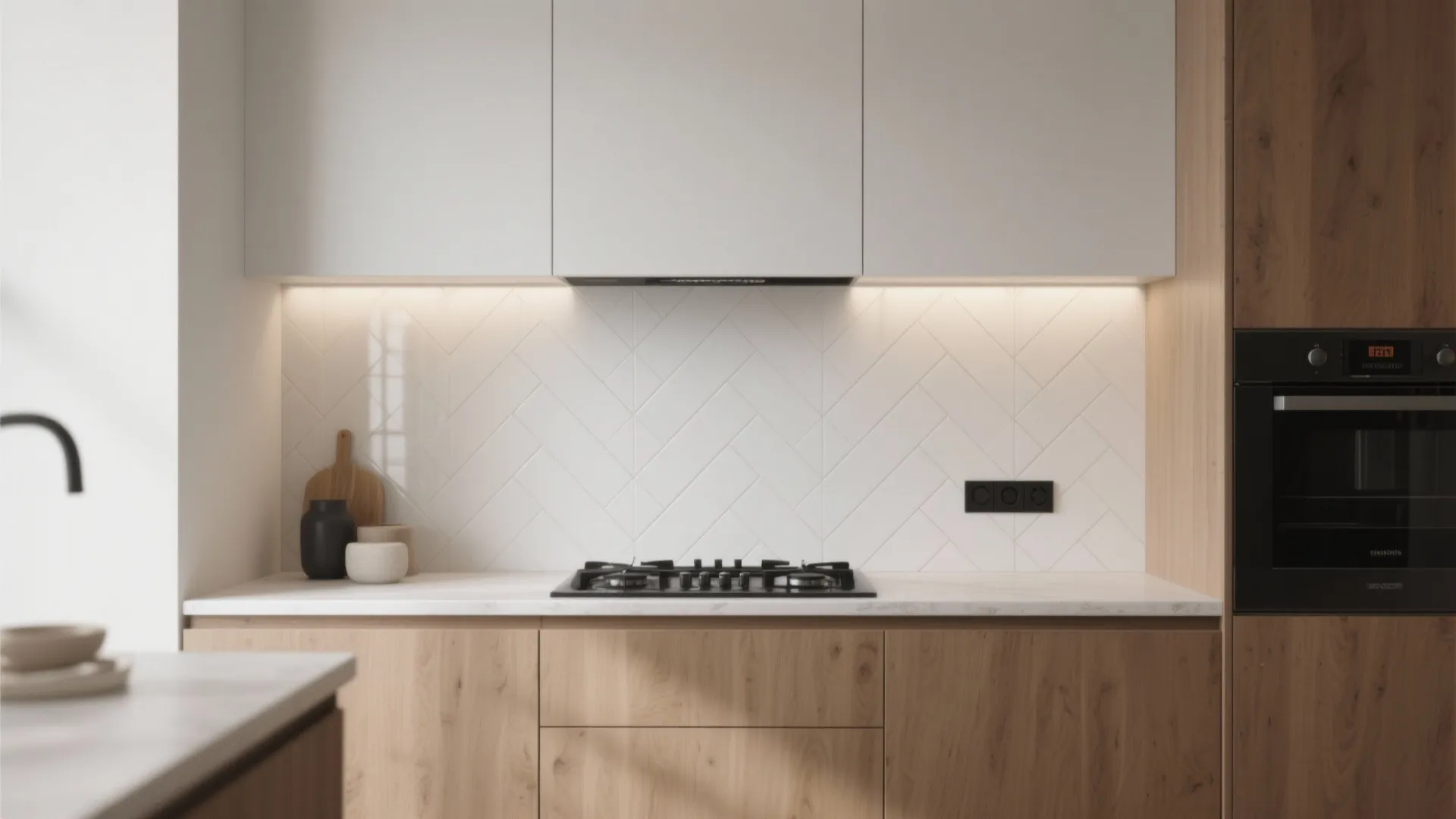 Minimalist kitchen with matte white porcelain herringbone backsplash and oak cabinets under soft task lighting.