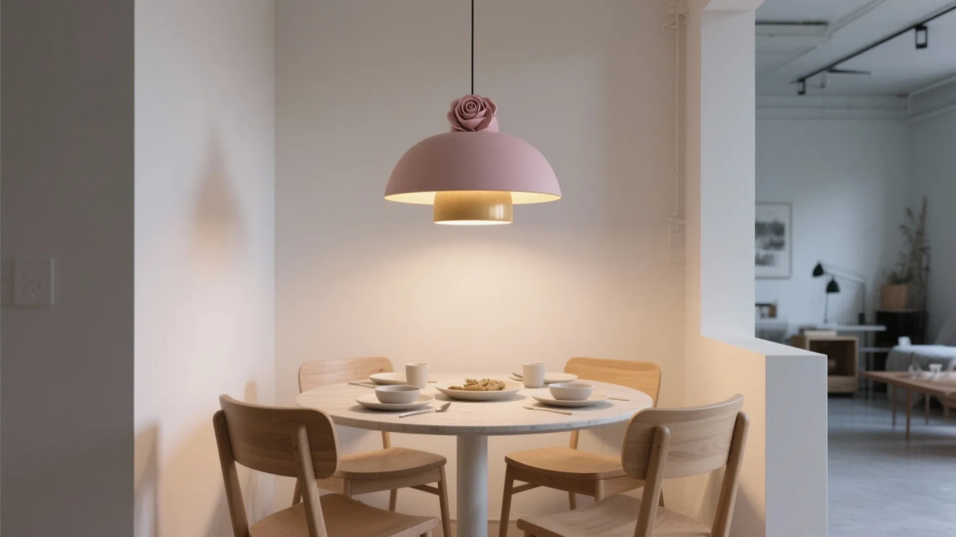Modern dining room with round marble table and pink dome light fixture featuring rose decoration