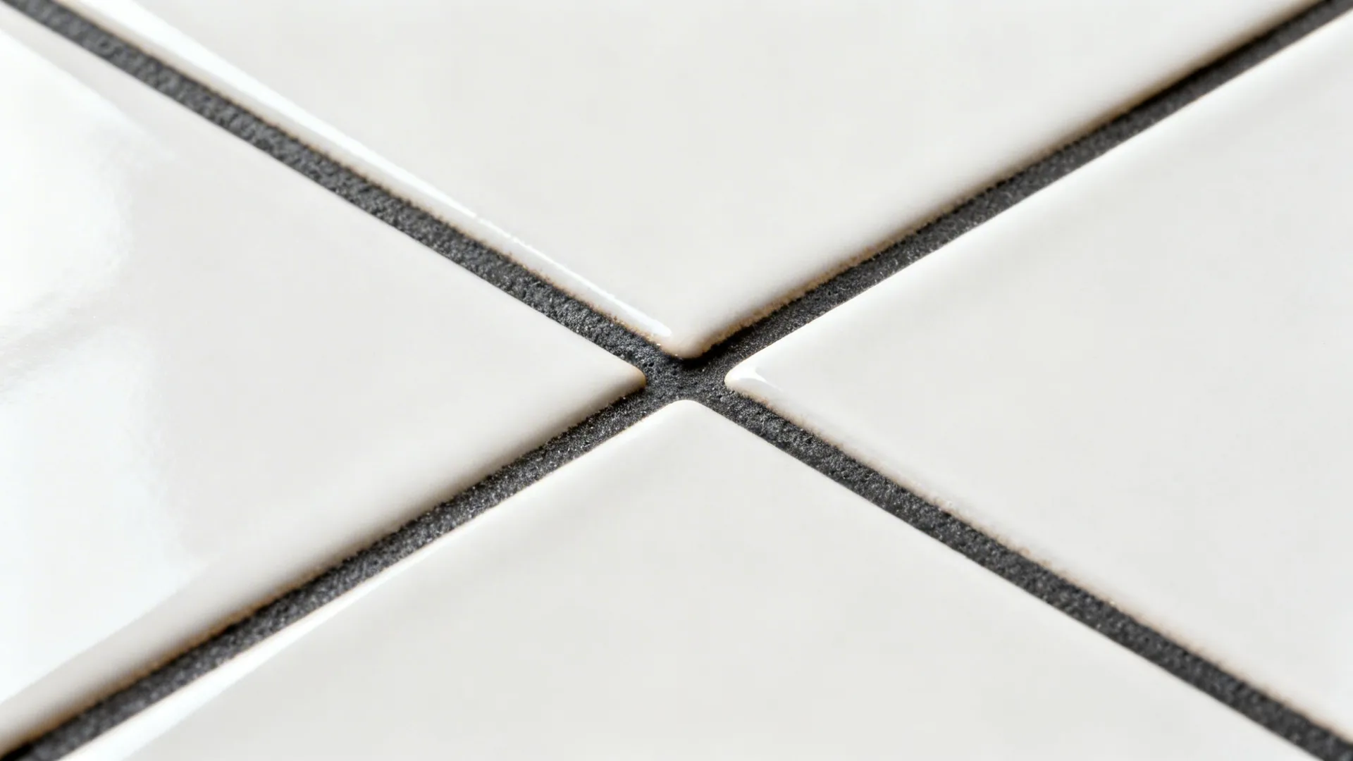 Macro view of matte white subway tile with charcoal grout highlighting subtle texture and clean lines.