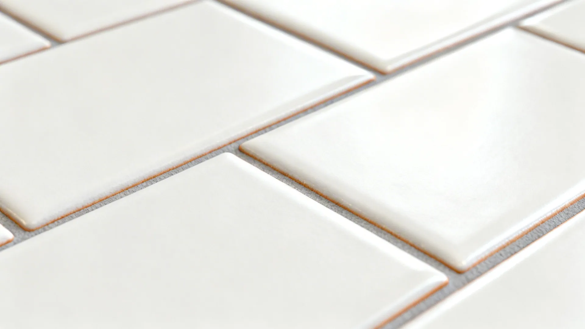 Macro of matte subway tiles with warm gray grout showing soft texture and tight 1/3 offset.