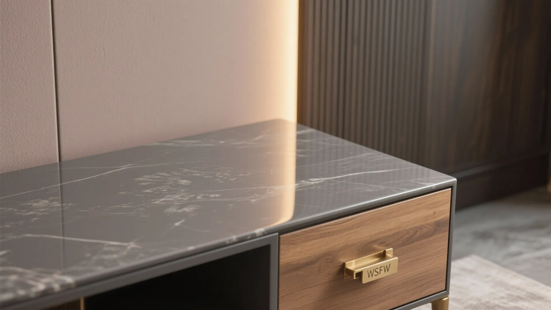 Close up of a wooden cabinet with a grey marble top and gold handle with text