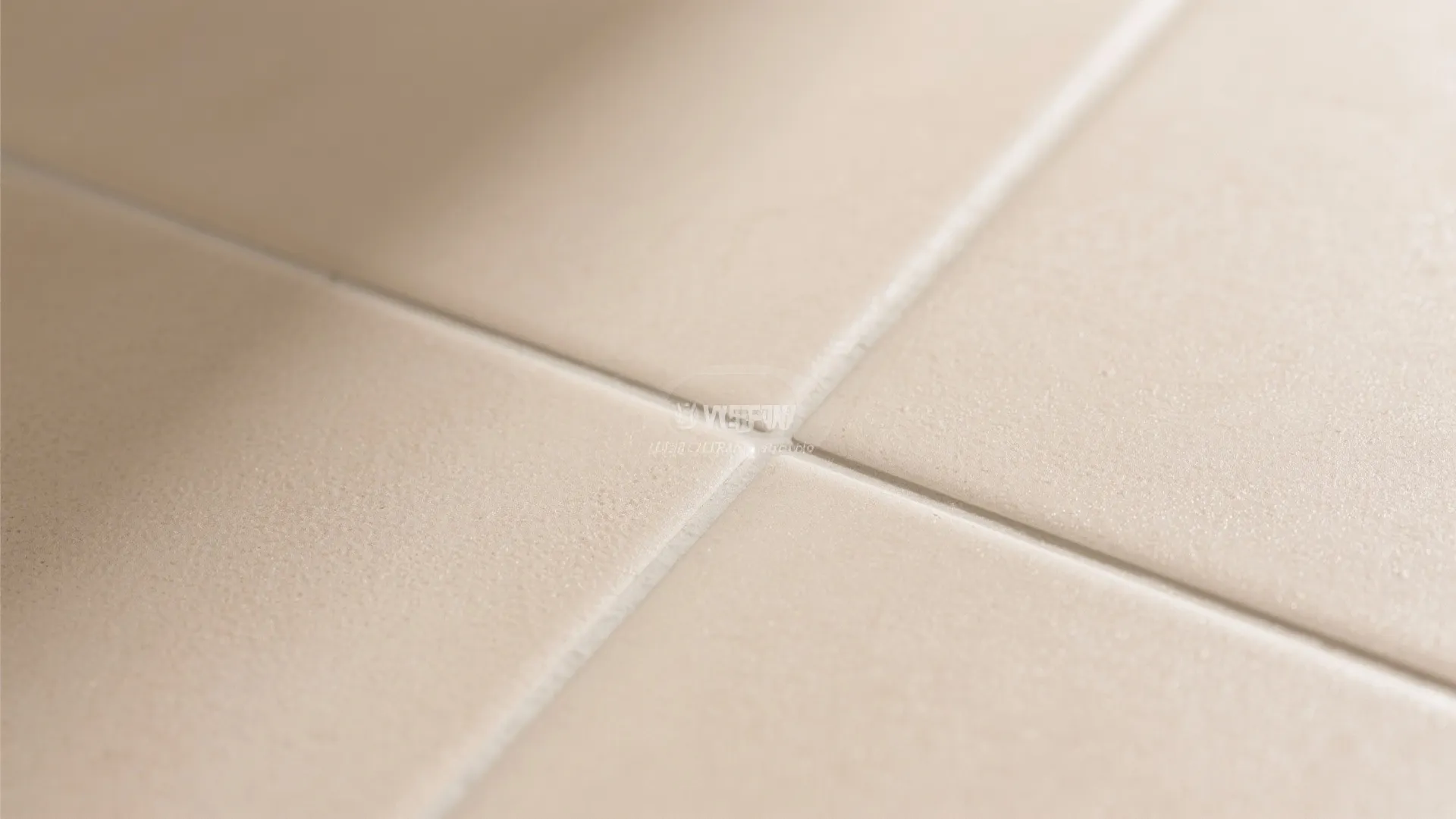 Close up view of clean beige floor tiles with white lines between each square tile