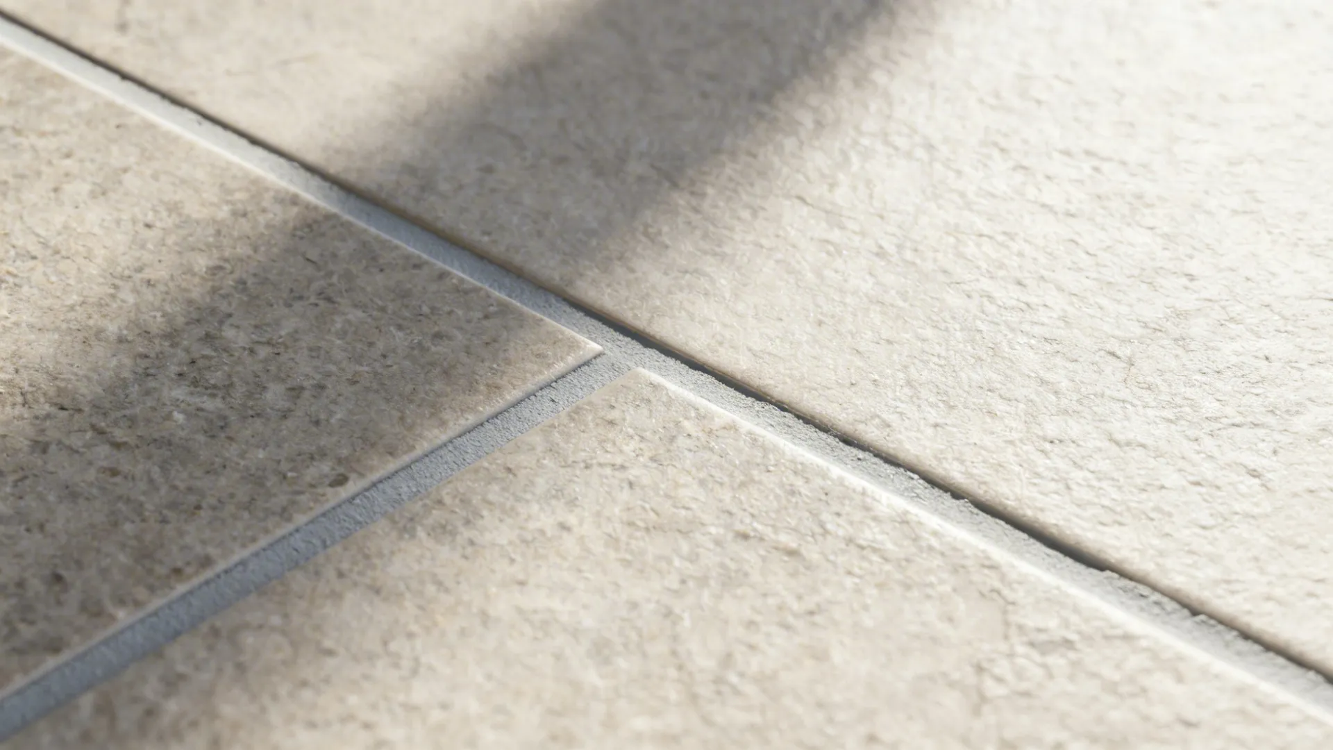 Macro of matte porcelain tile with subtle texture and light-gray epoxy grout.