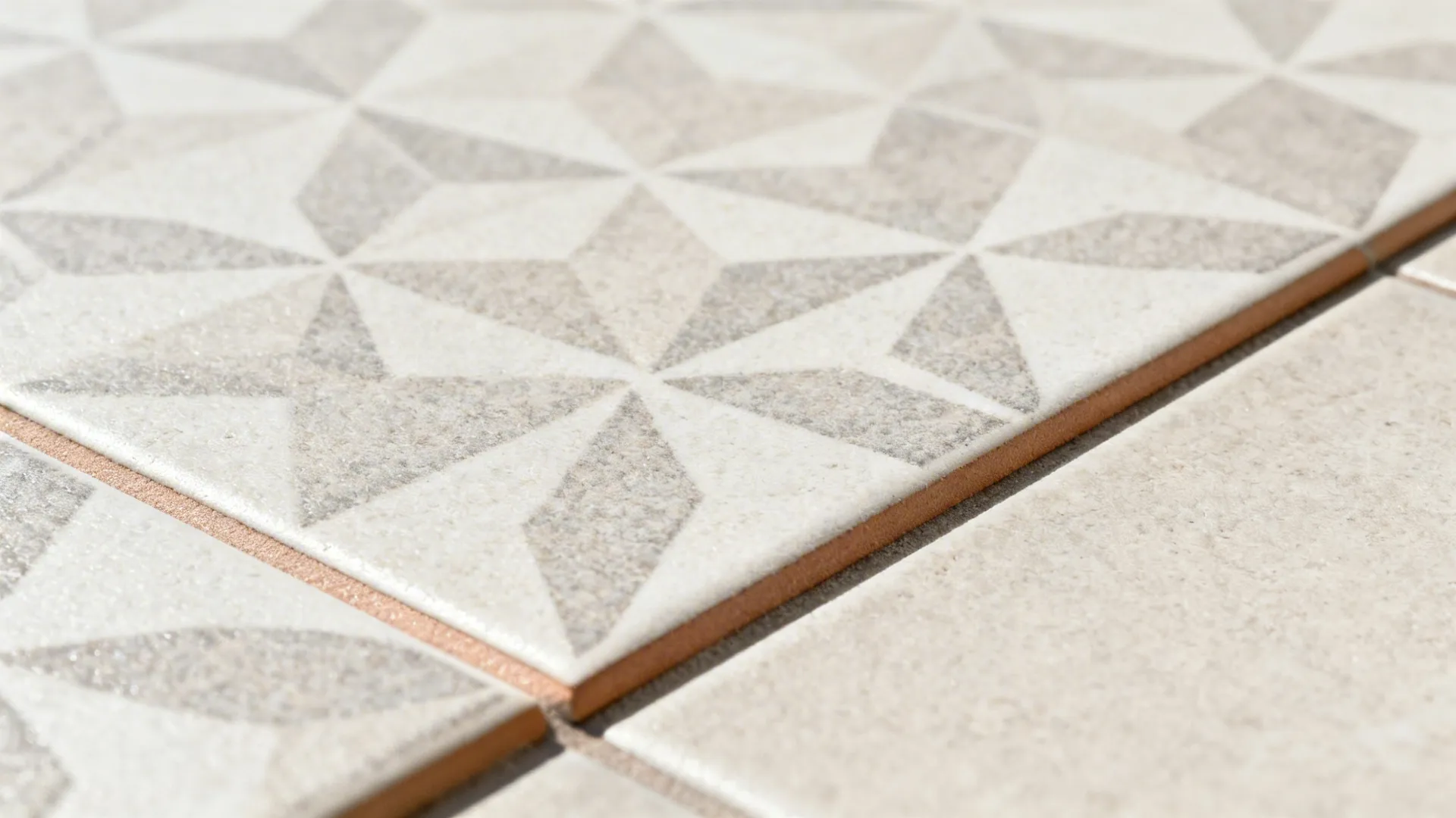 Macro of matte porcelain tile with slip-resistant texture and narrow grout joint.