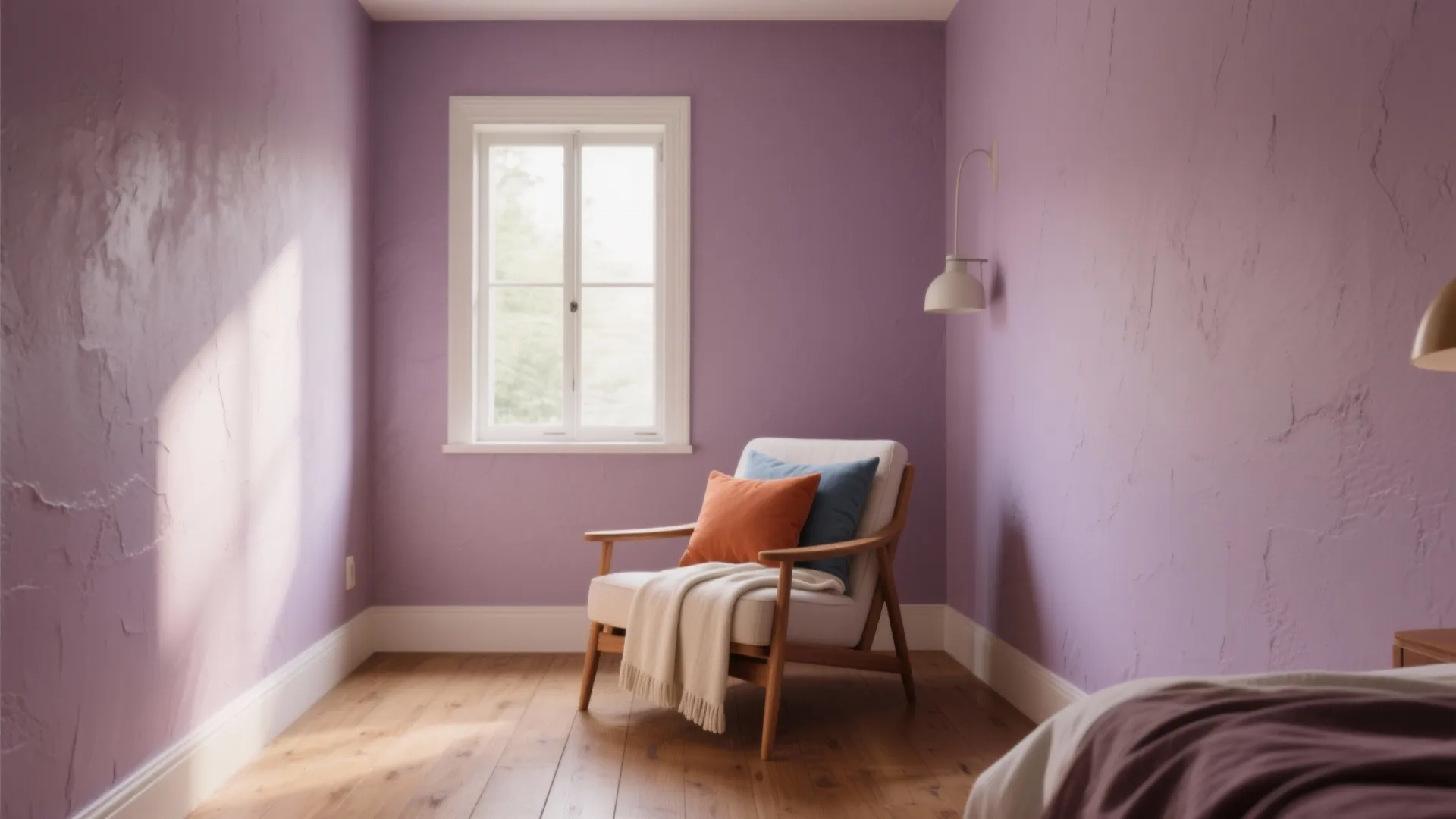 Purple living room corner with white armchair, colorful pillows, white wall light, window, and wood floor
