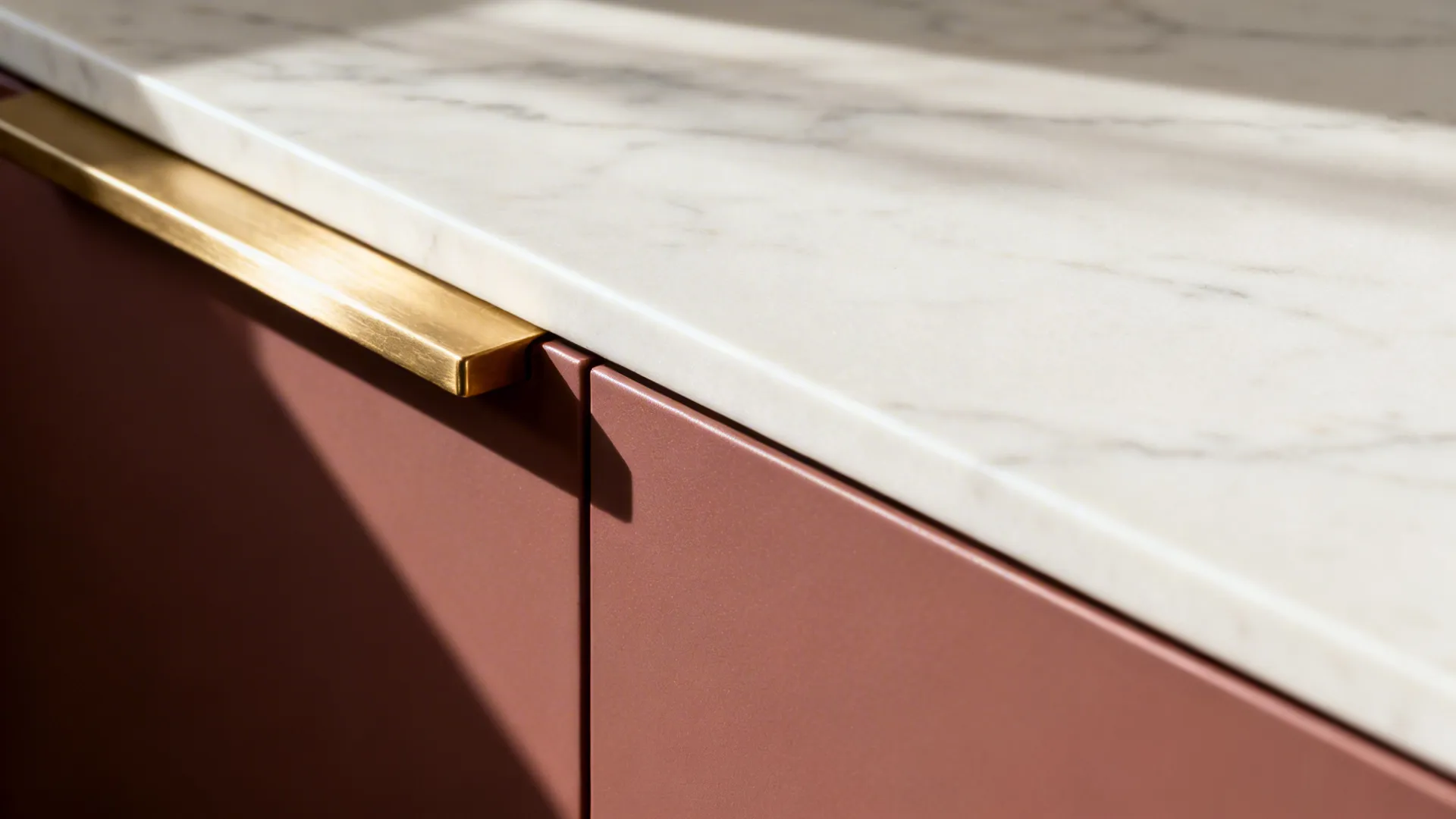 Mehroon matte cabinetry with light stone counters