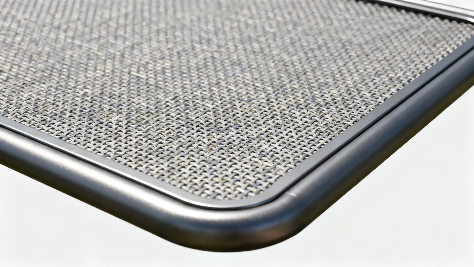 Macro detail of stainless woven mesh set in a powder-coated steel frame with rounded trims.