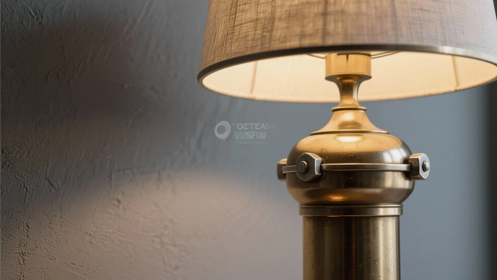 Close up of a warm vintage brass table light fixture against a dark grey textured wall