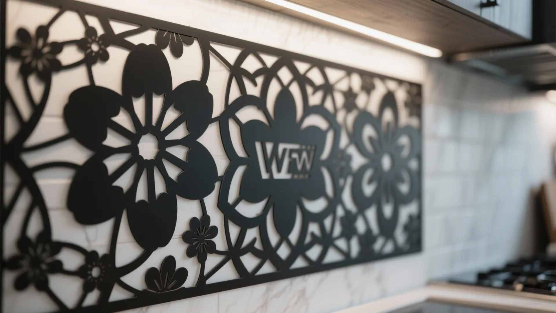 Black laser cut floral metal wall art mounted on white tile backsplash in modern kitchen