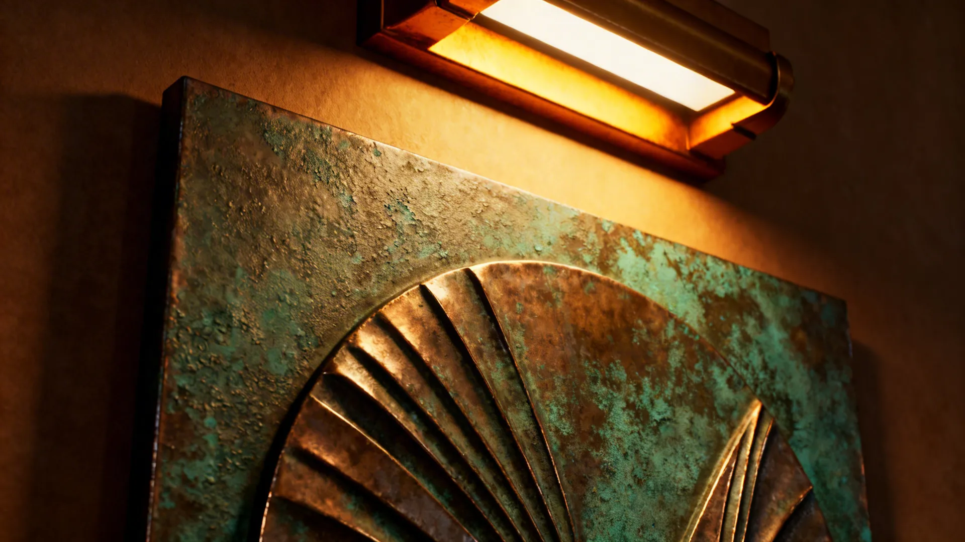 Green metal wall art with circular pattern lit by a warm light fixture on wall